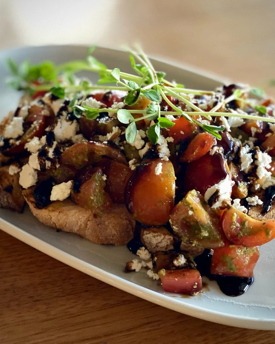 Bring on the Bruschetta! It's great as a snack or before you tuck into one of our main meals, especially on a summer's day. Cherry and roma tomatoes, basil pesto, feta, balsamic glaze, and sourdough at its finest.