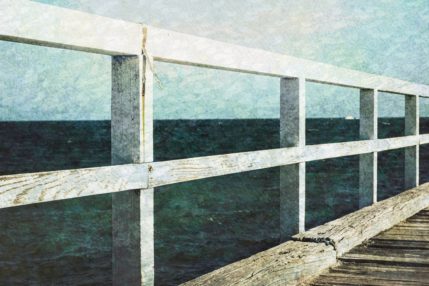 Colour photograph of seaside pier railing over looking the ocean, with a French Impressionist painterly effect.