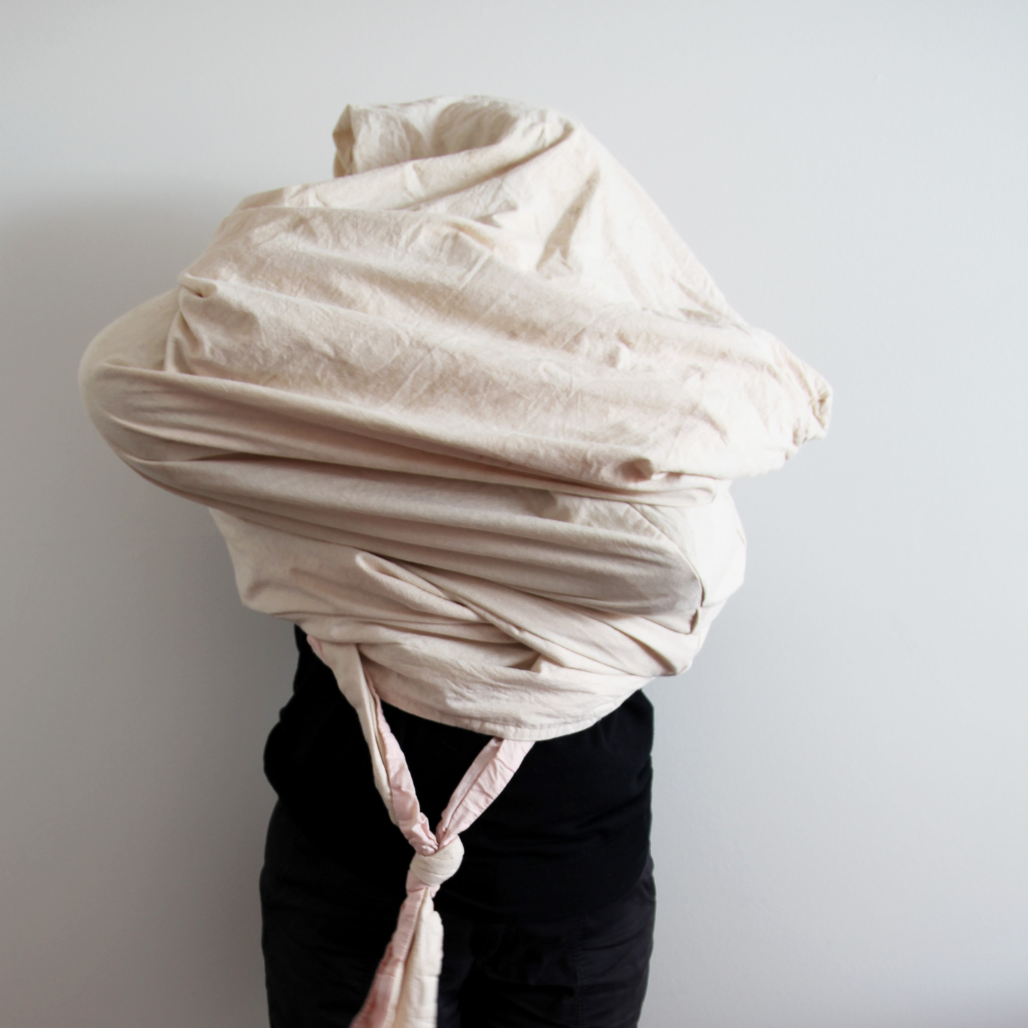 Person with their head and body enclosed in cloth bag.