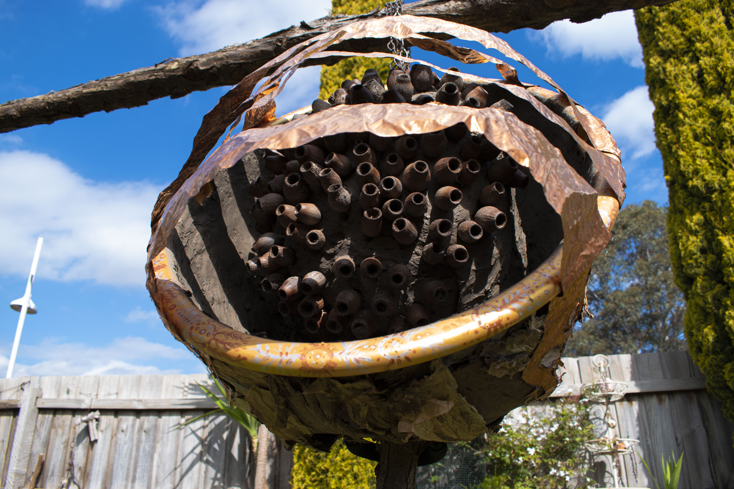 close up of orb like structure of found natural materials/ recycled copper