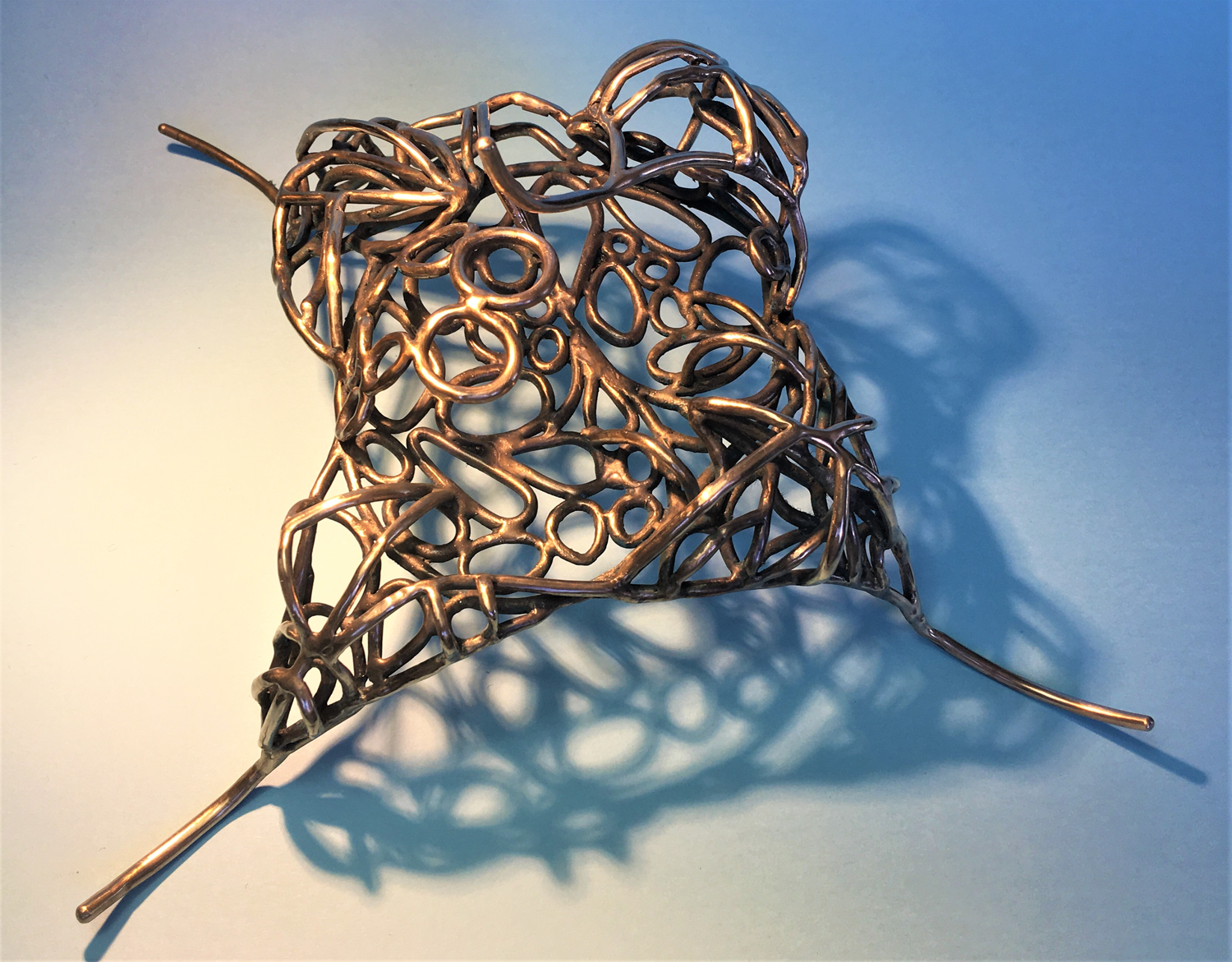 A bronze sculpture comprised of wire like cell like sculpture inspired by the cells found within insect wings and the vein like structure within leaves. 