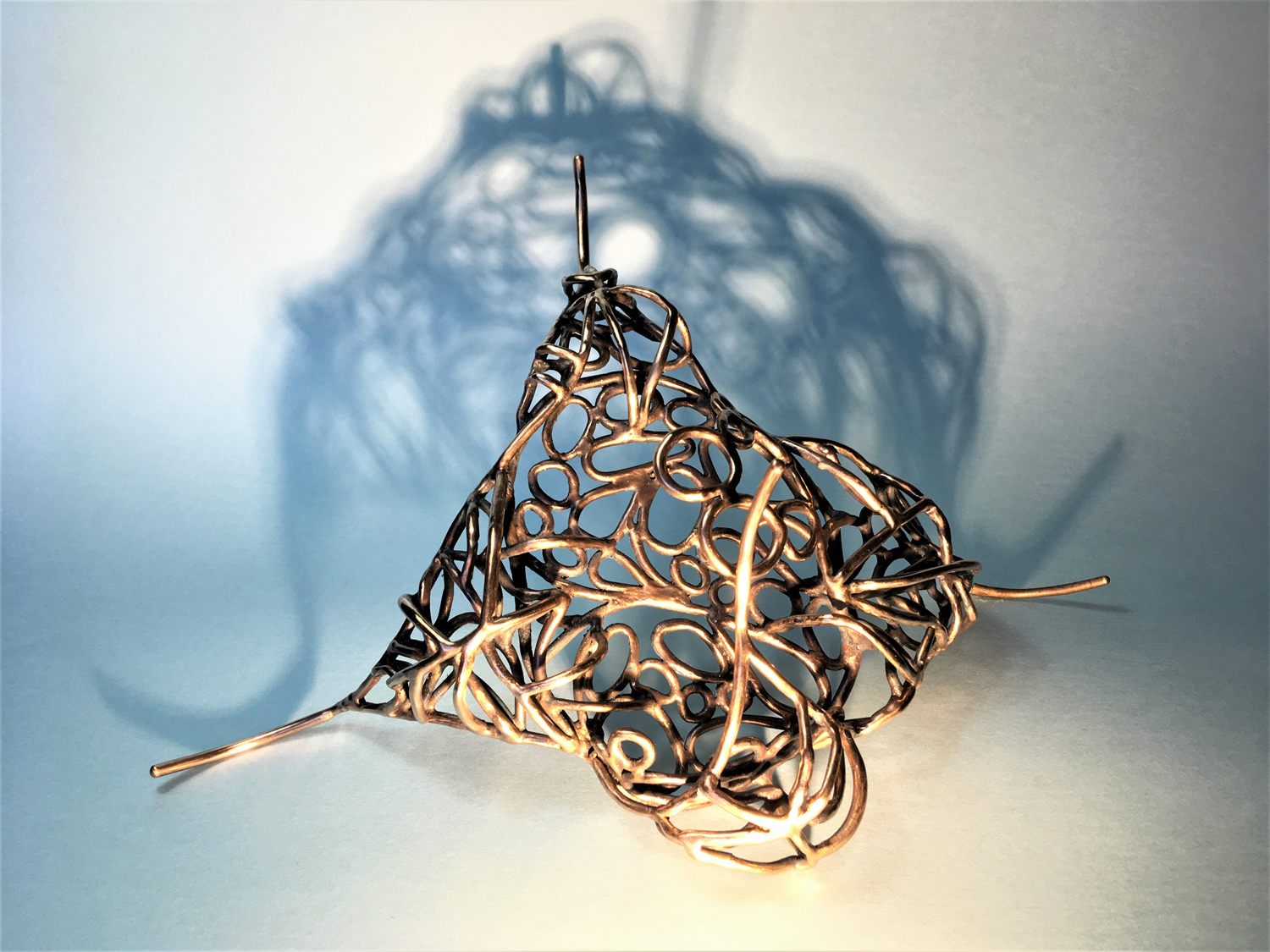 A bronze sculpture comprised of wire like cell like sculpture inspired by the cells found within insect wings and the vein like structure within leaves. 