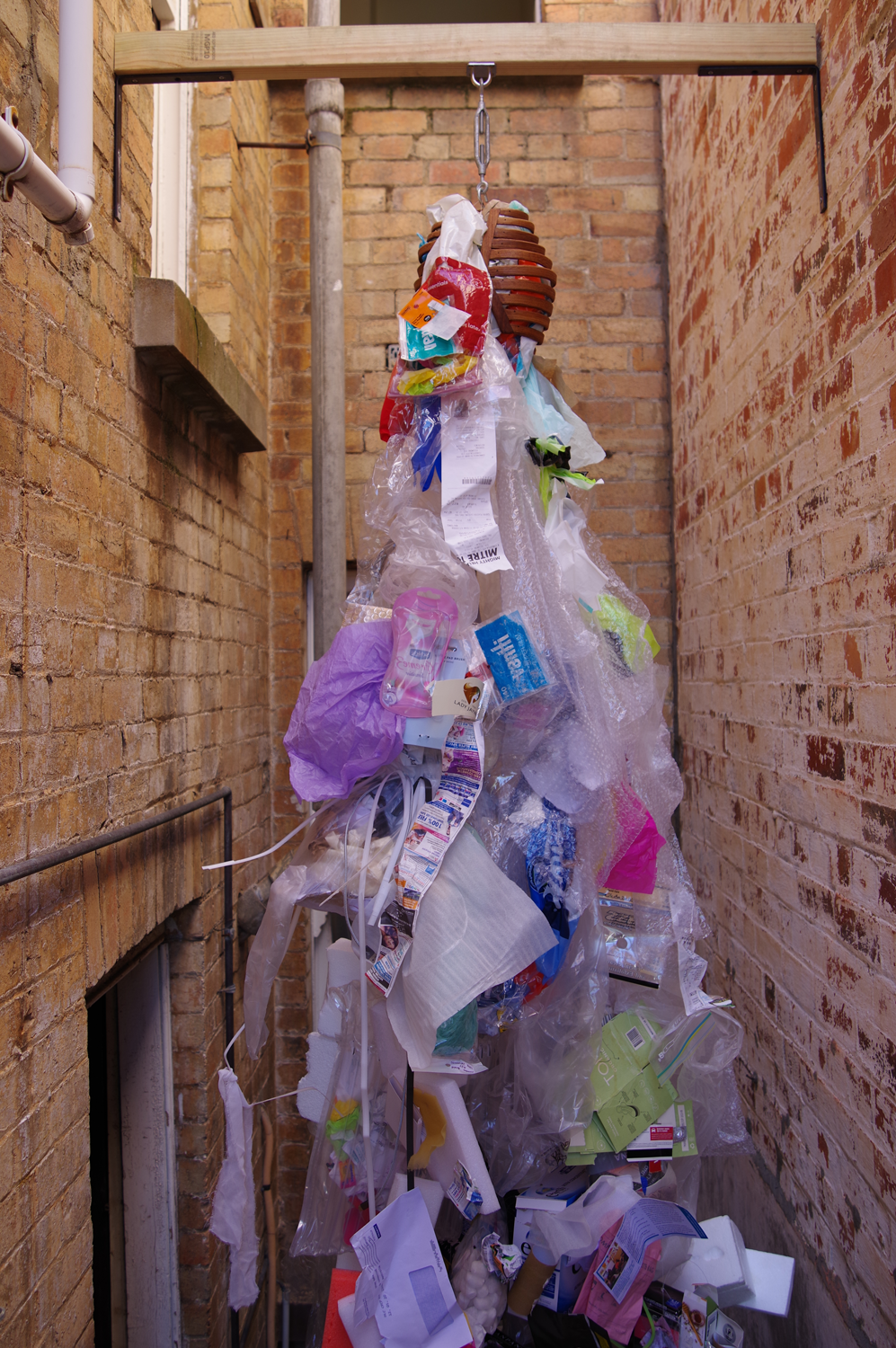 Photo of top half of the work ribcage with spilling out of it rubbish 