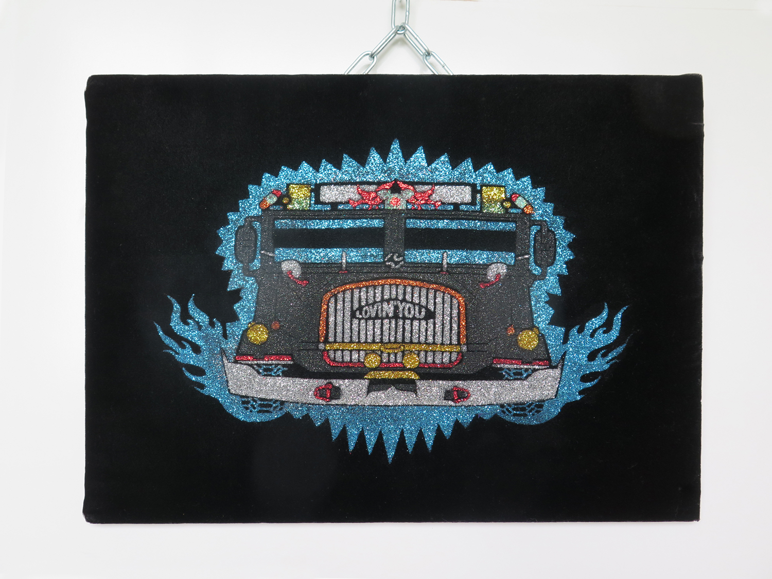 A padded velvet work featuring a multiple colour glitter screenprint of a truck called with Lovin' You on the grill. 
