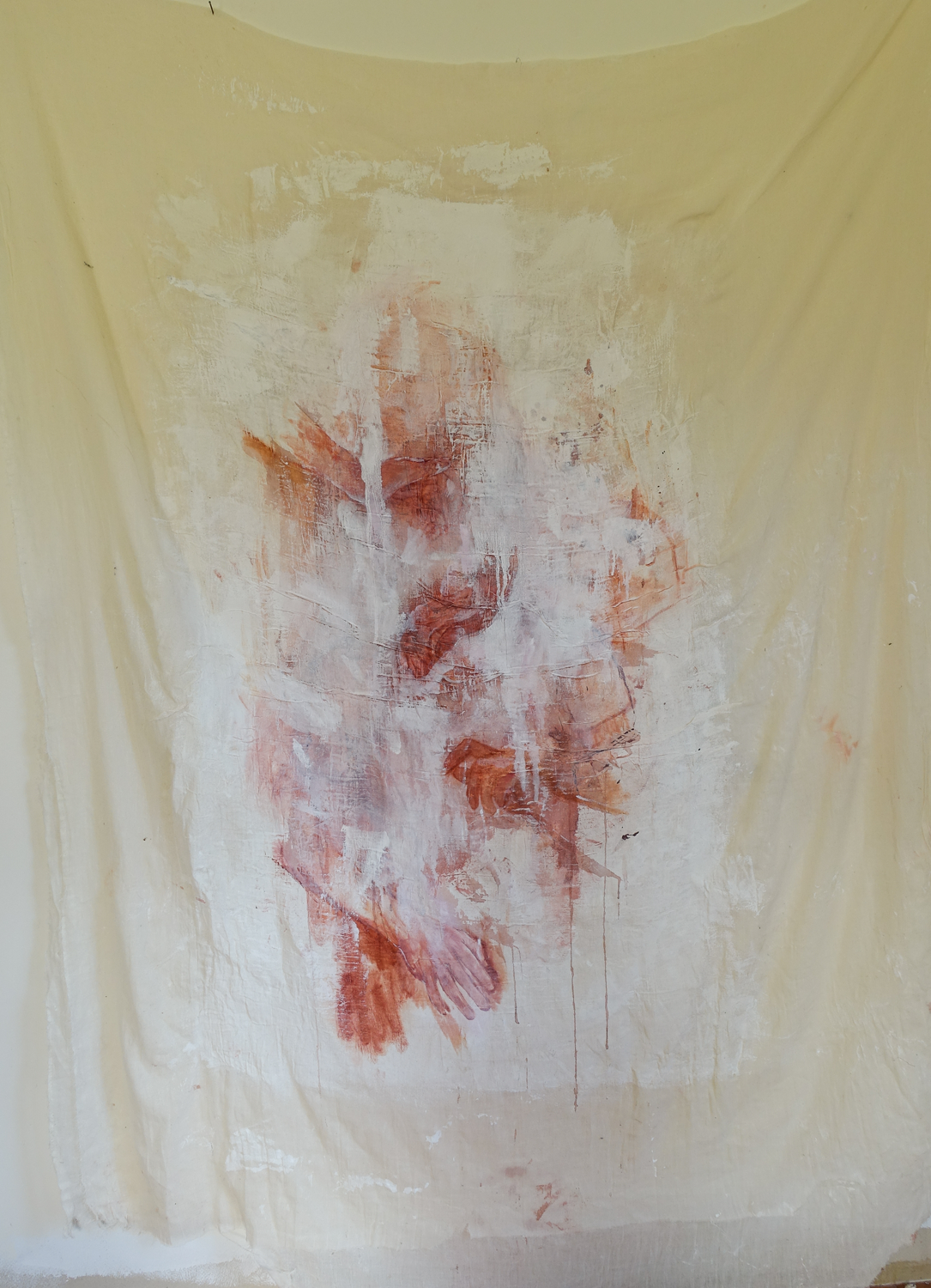 Large painting on thin cheesecloth like fabric, fragments of hands can be seen through white abstract marks, smudges and paint drips. The painting in warm toned reds and pinks