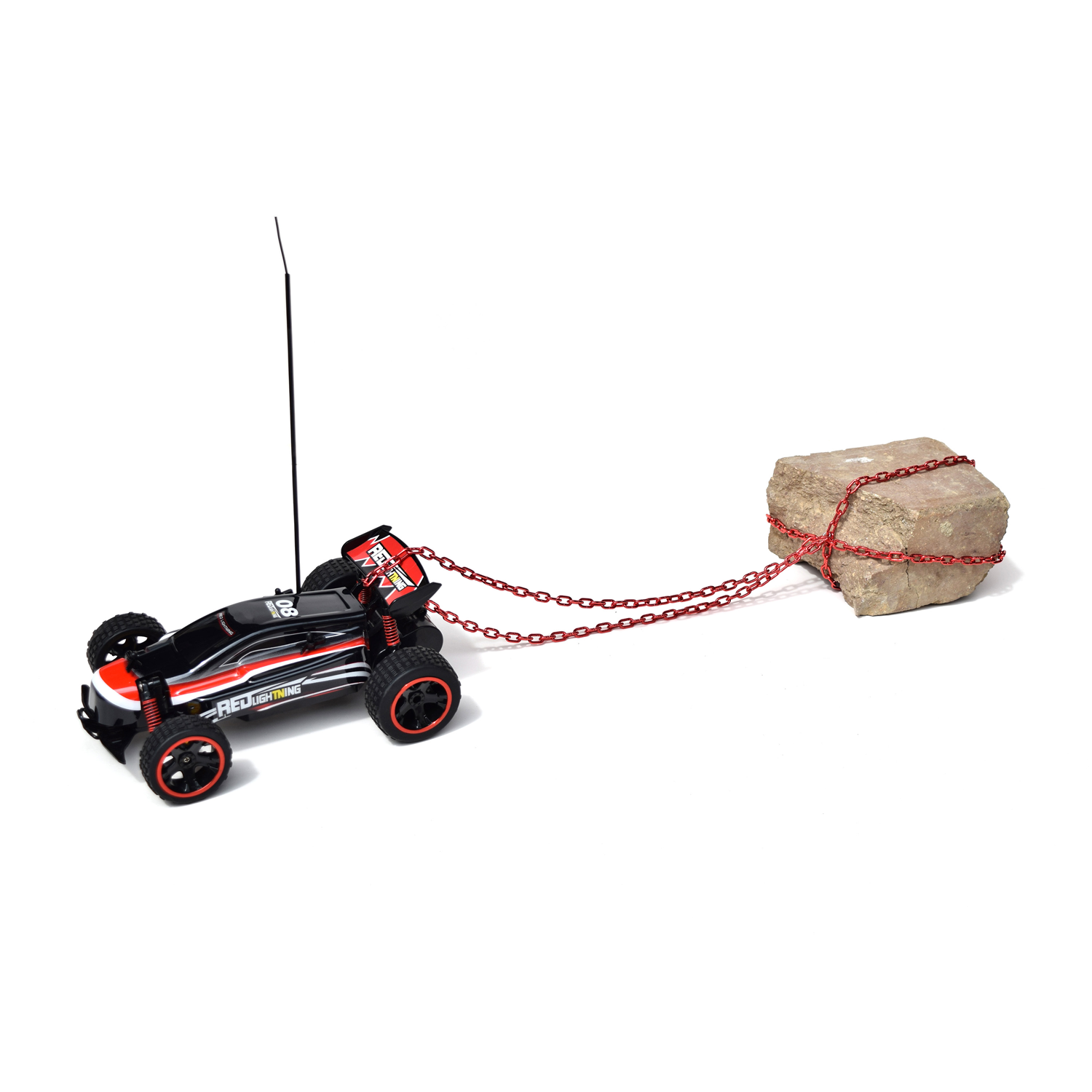 A toy race car with a brick chained to the back of it.
