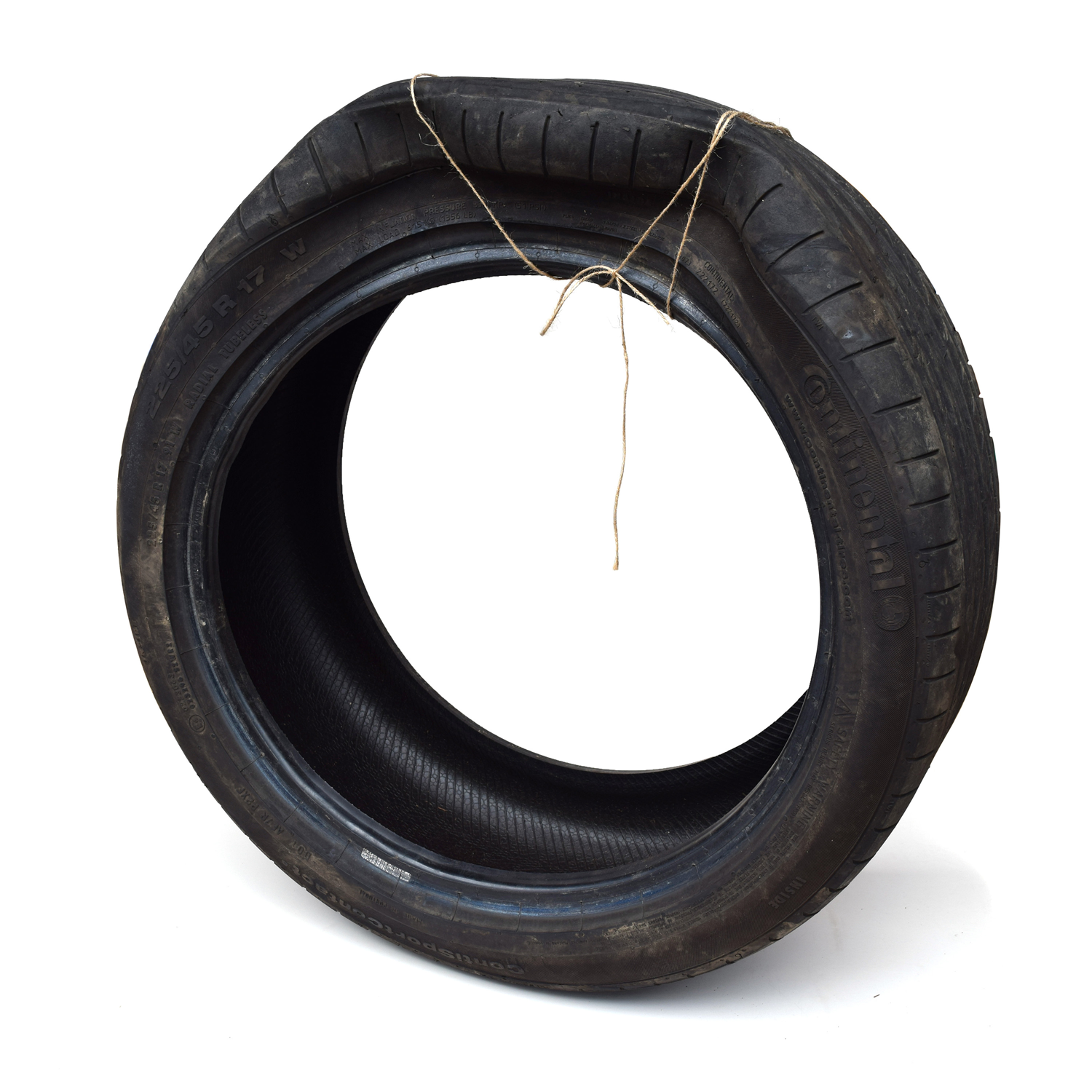 A deformed car tire wrapped with a piece of twine