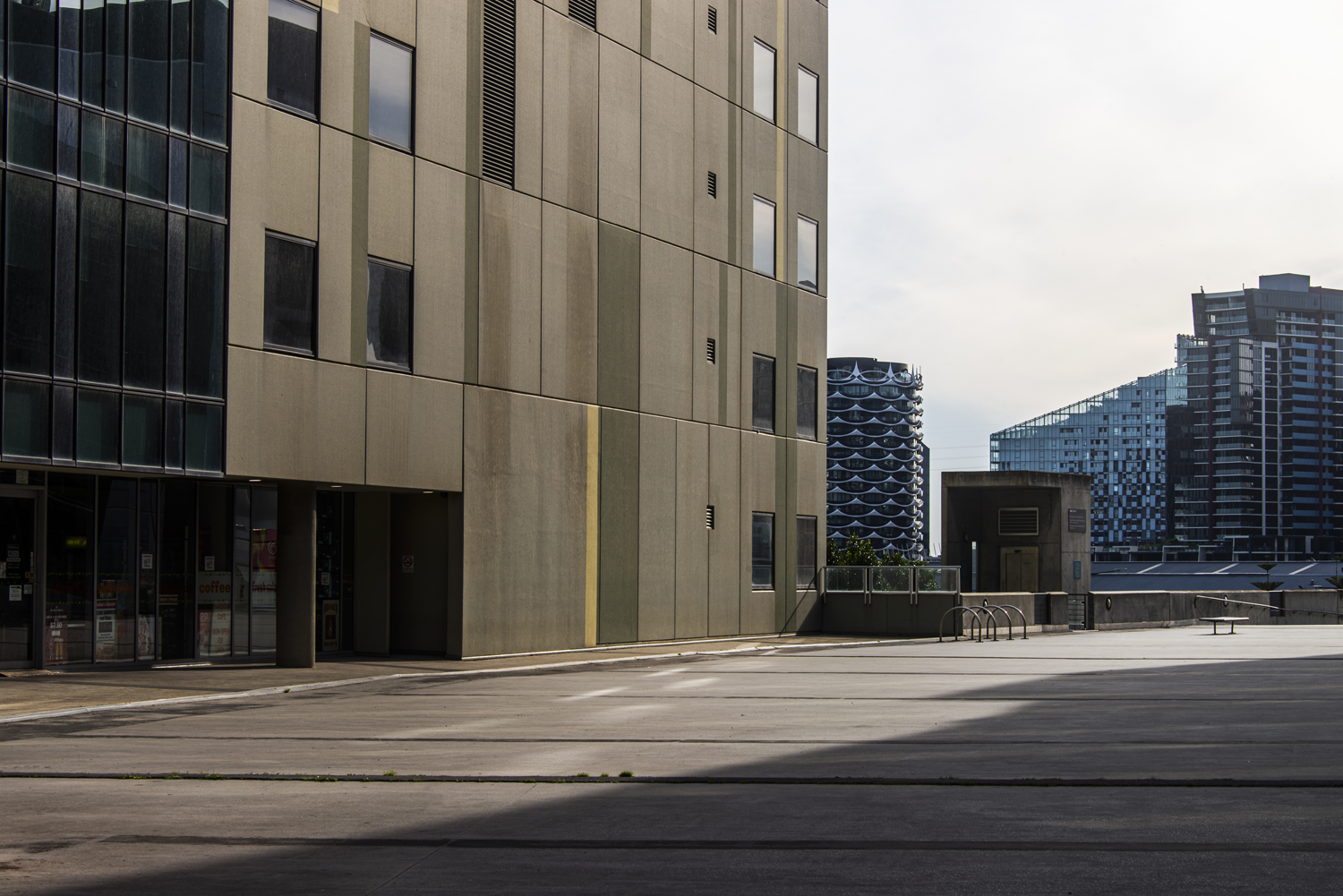 Colour photograph of residential city buildings that leave little space for the sky to be seen. 