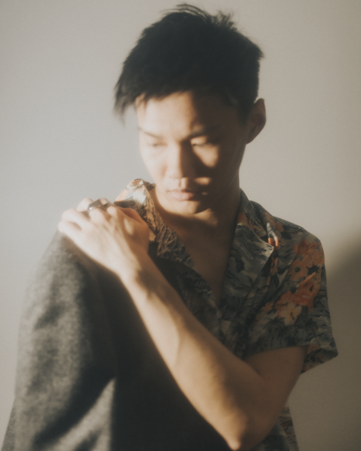 Colour photograph of a soft focused self-portrait of the artist in a silk shirt and blazer.