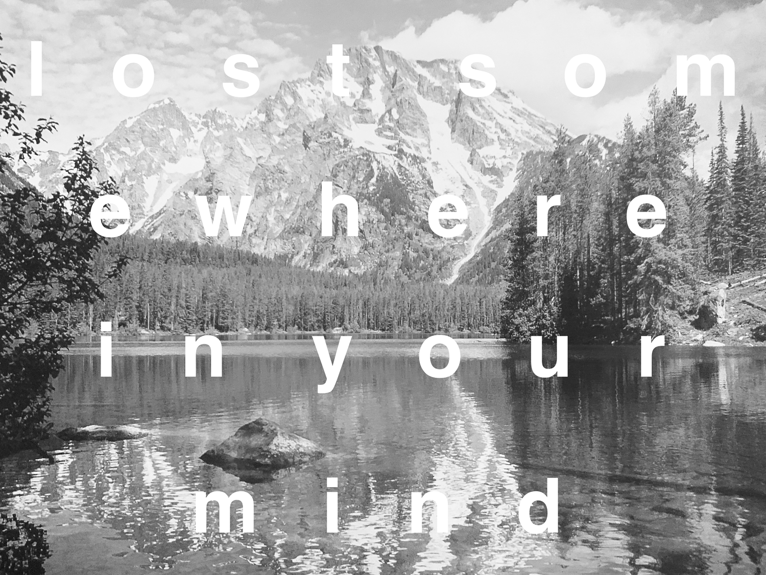 text layered on greyscale lake and mountain landscape