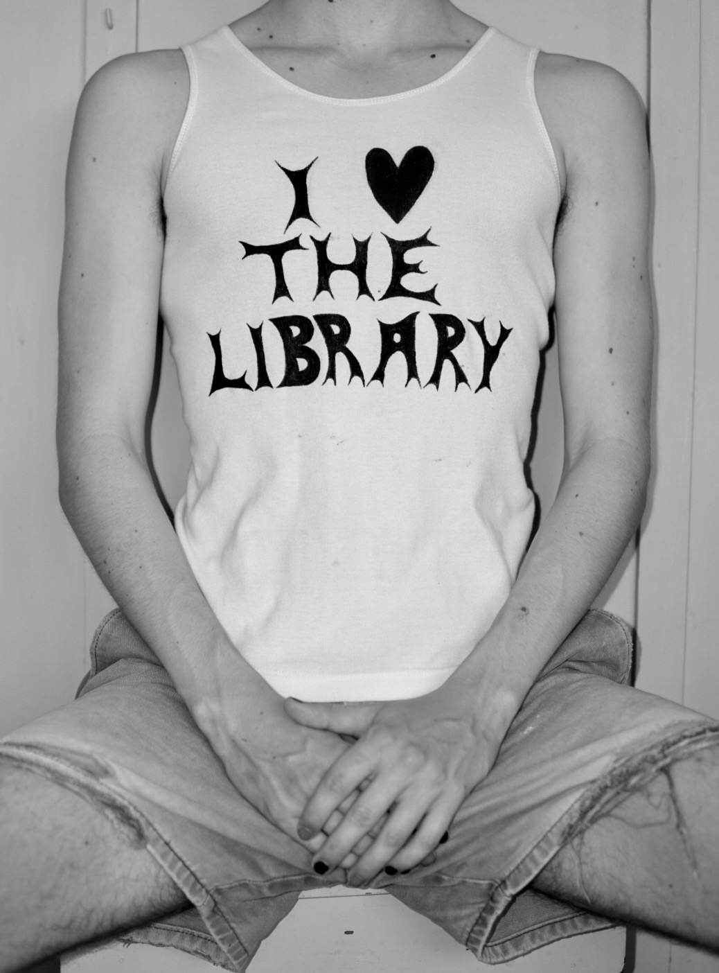 Female torso wearing singlet with 'I Love the Library' written in graphic writing.