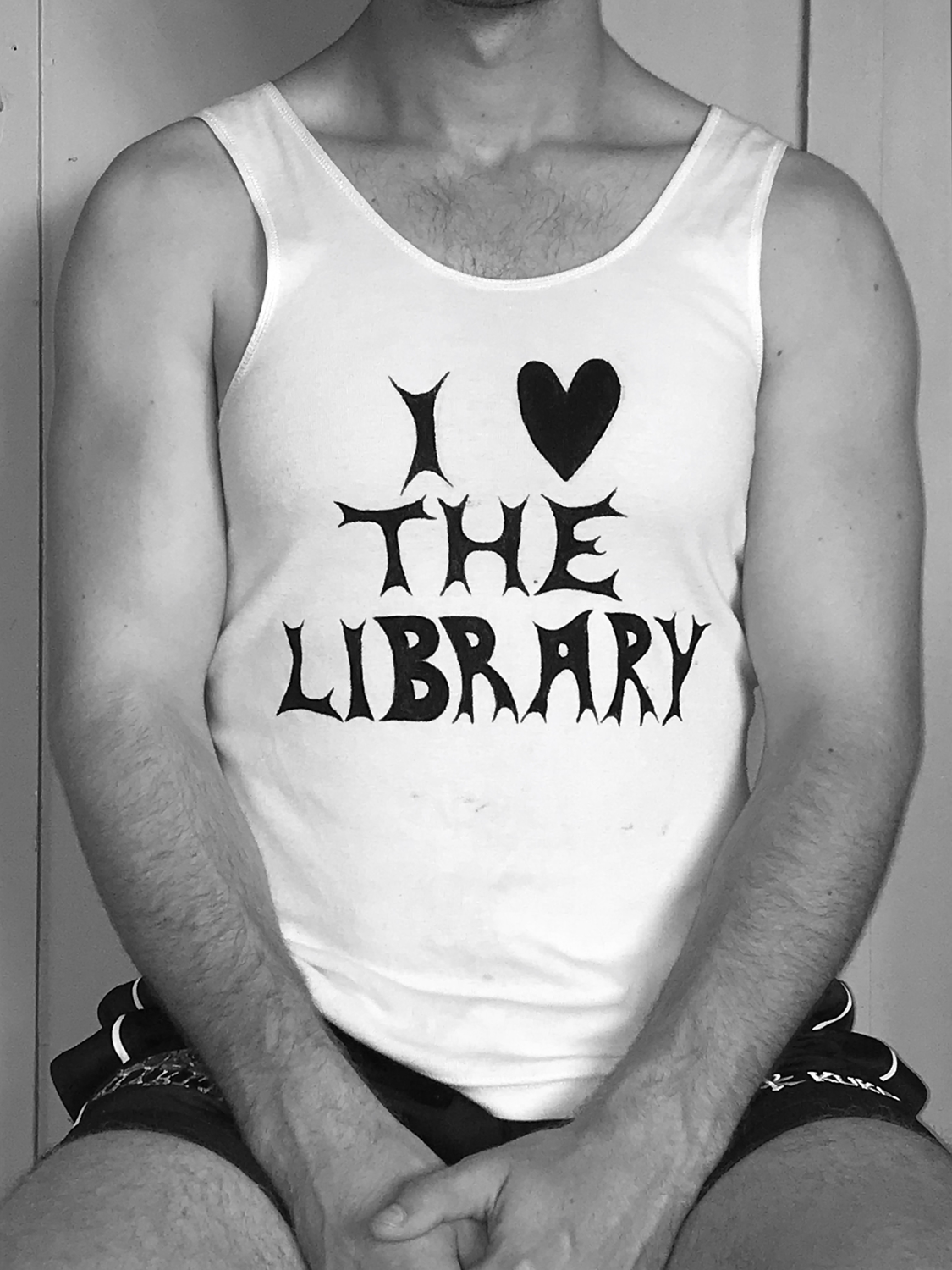 Male torso wearing singlet with 'I Love the Library' written in graphic writing.