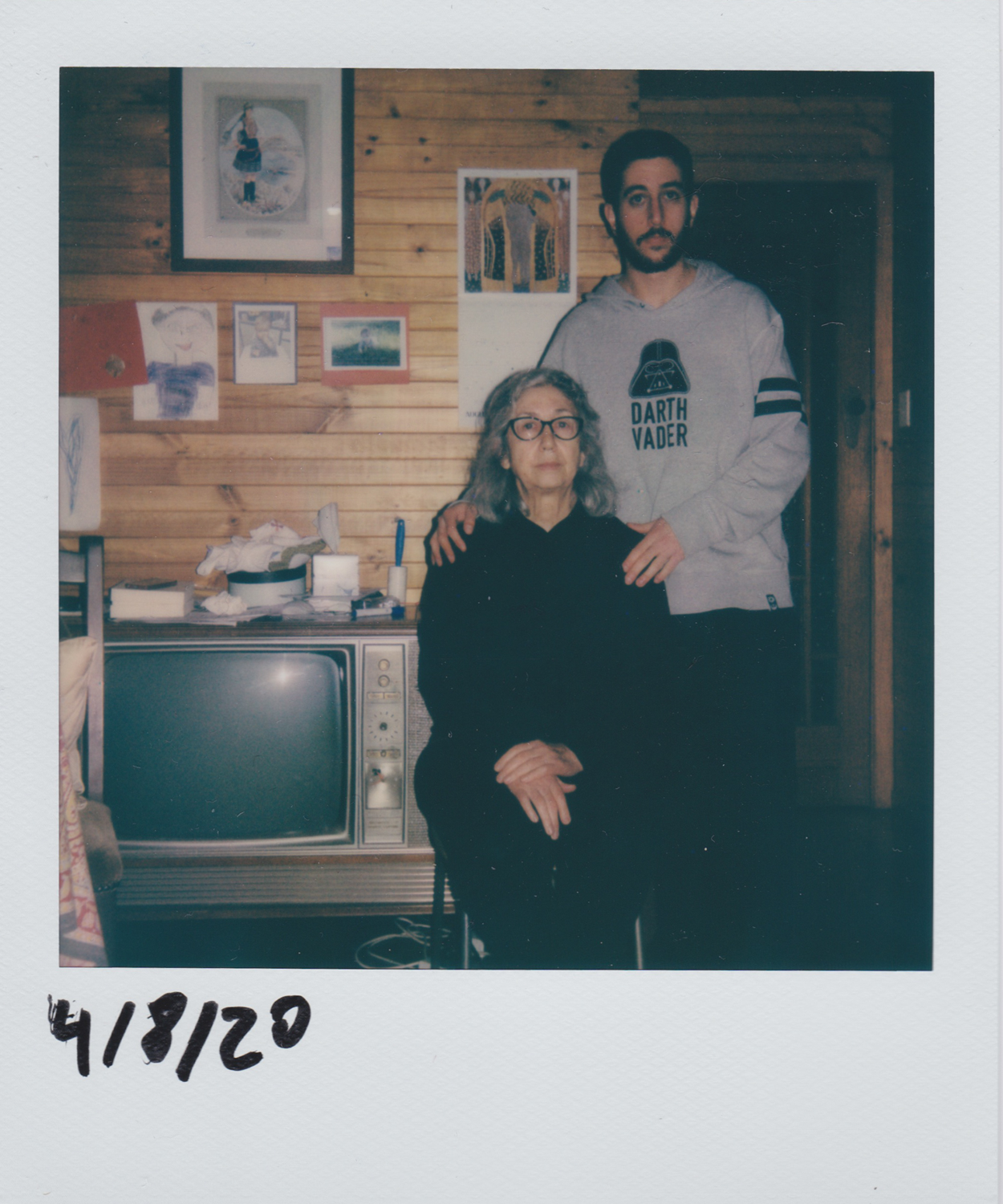 Colour polaroid of the artist and mother posed in a domestic environment. 