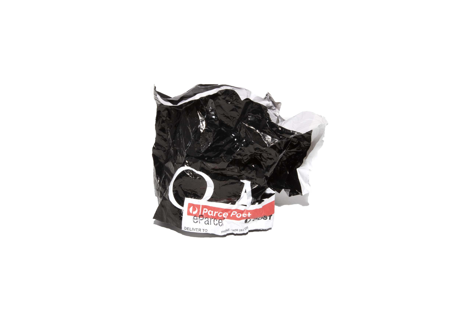 Colour photograph depicting crumpled postage packaging.