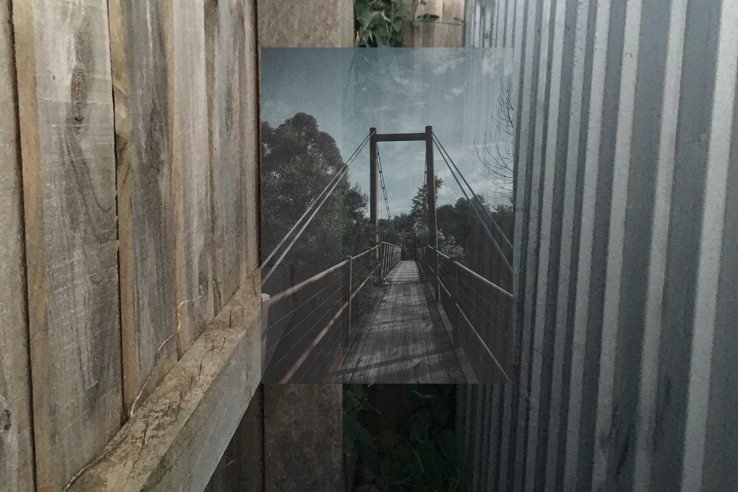 A digital collage of a narrow walk way and a bridge 