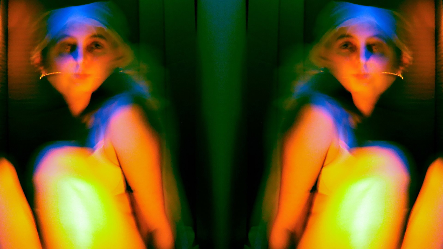 A series of brightly coloured and contrasting photographs of abstract self portraiture. 