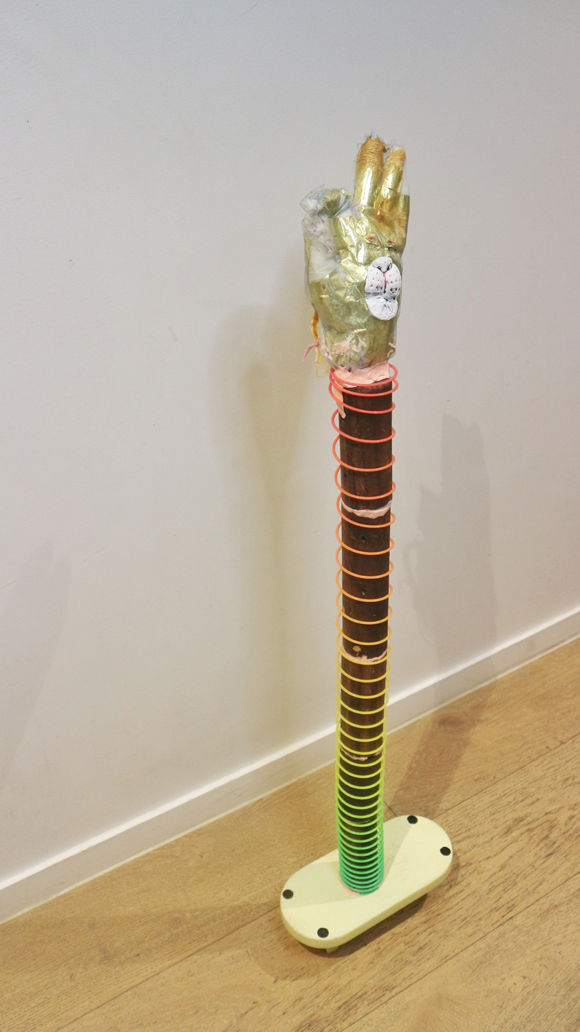 material assemblage sculpture with ok gesture 