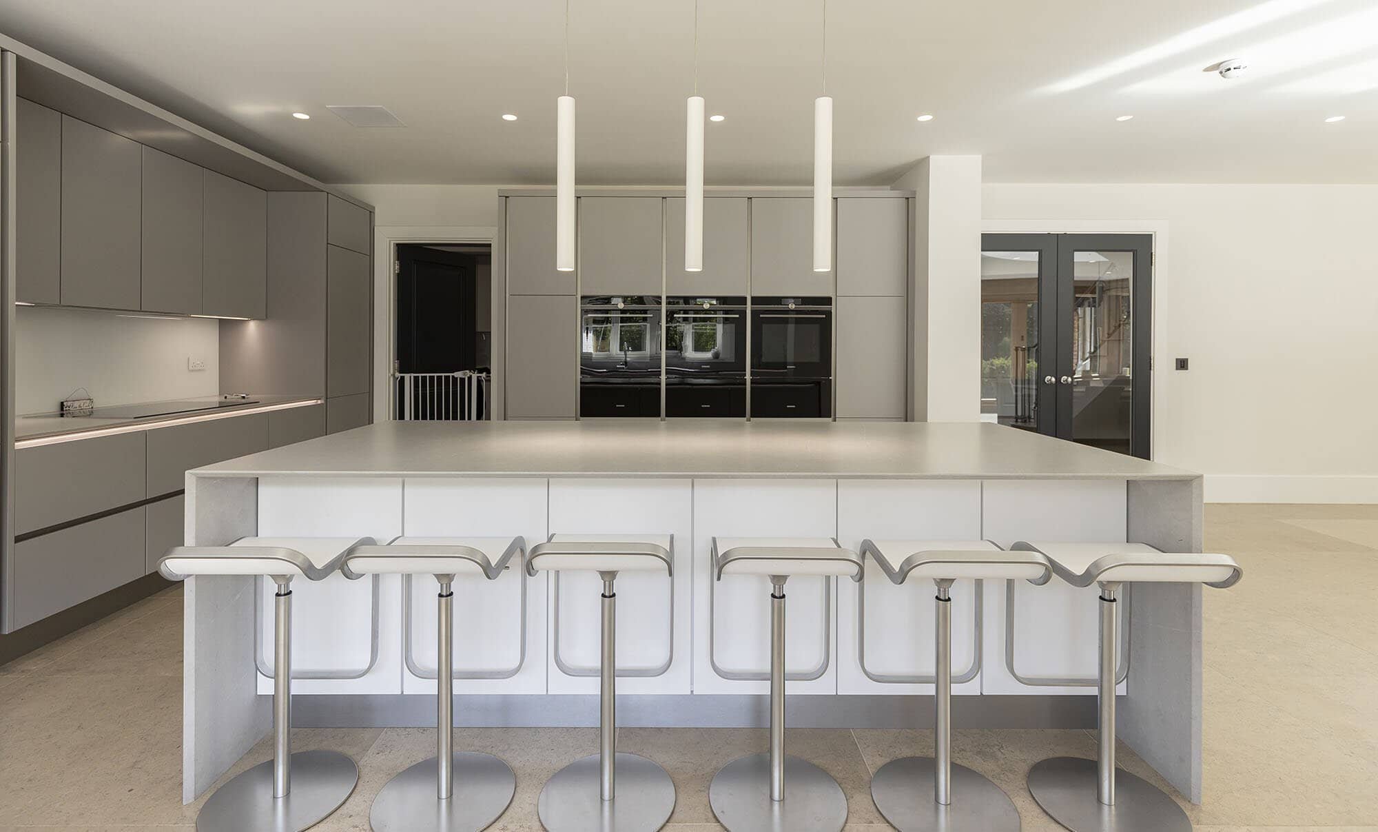 MODERN OPEN-PLAN WHITE AND GREY KITCHEN ON MILL LANE