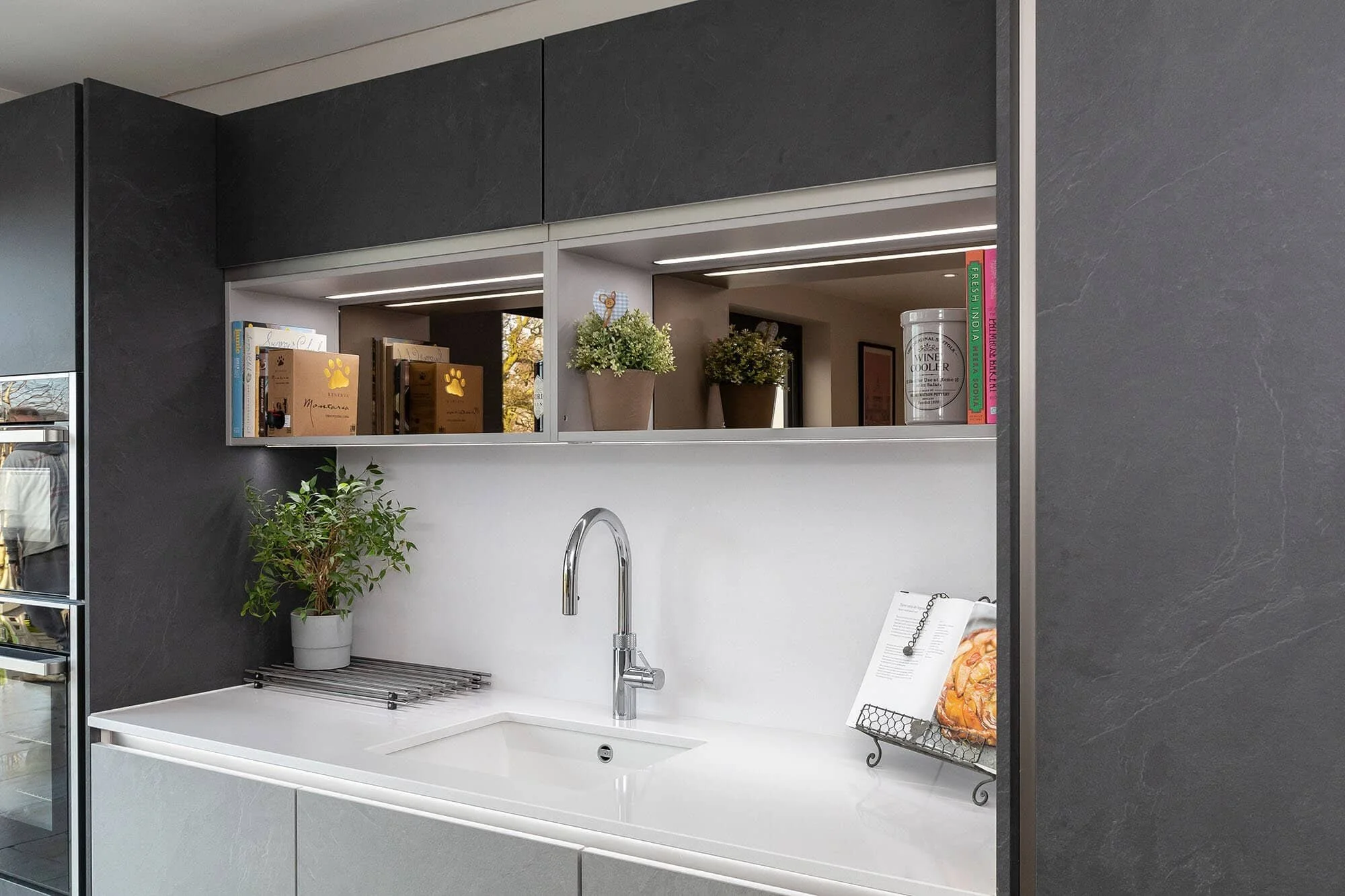 AN OPEN-PLAN INDUSTRIAL TWO-TONE KITCHEN ON CORNER WOOD