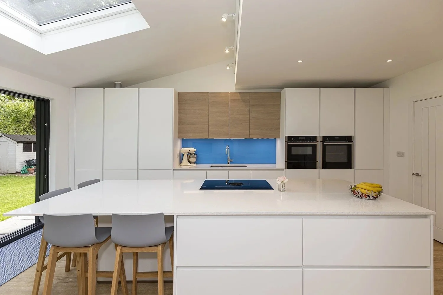 MODERN WHITE KITCHEN WITH A POP OF BLUE ON BOOTH DRIVE