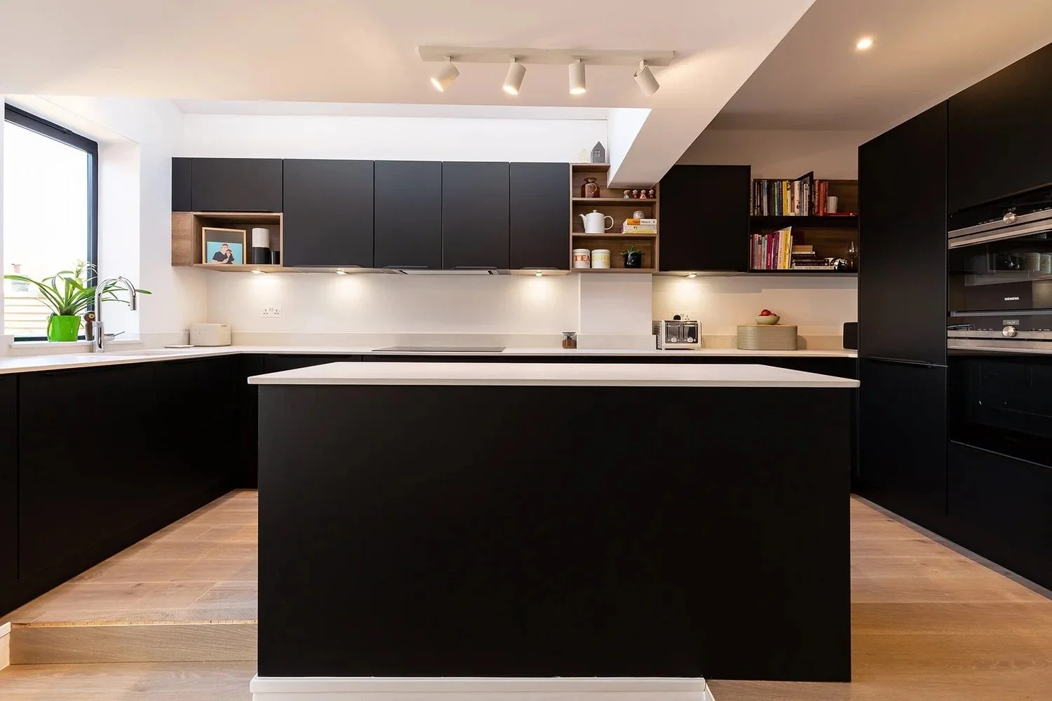 SLEEK BLACK KITCHEN WITH WOODEN ACCENTS ON CANNON STREET