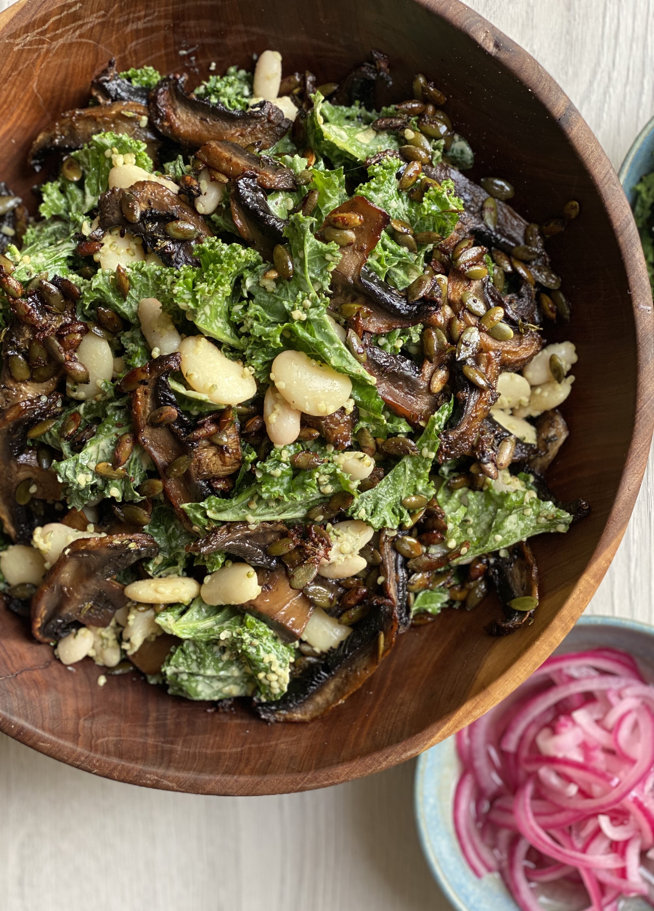 Kale and white bean caesar salad with pink pickled onions
