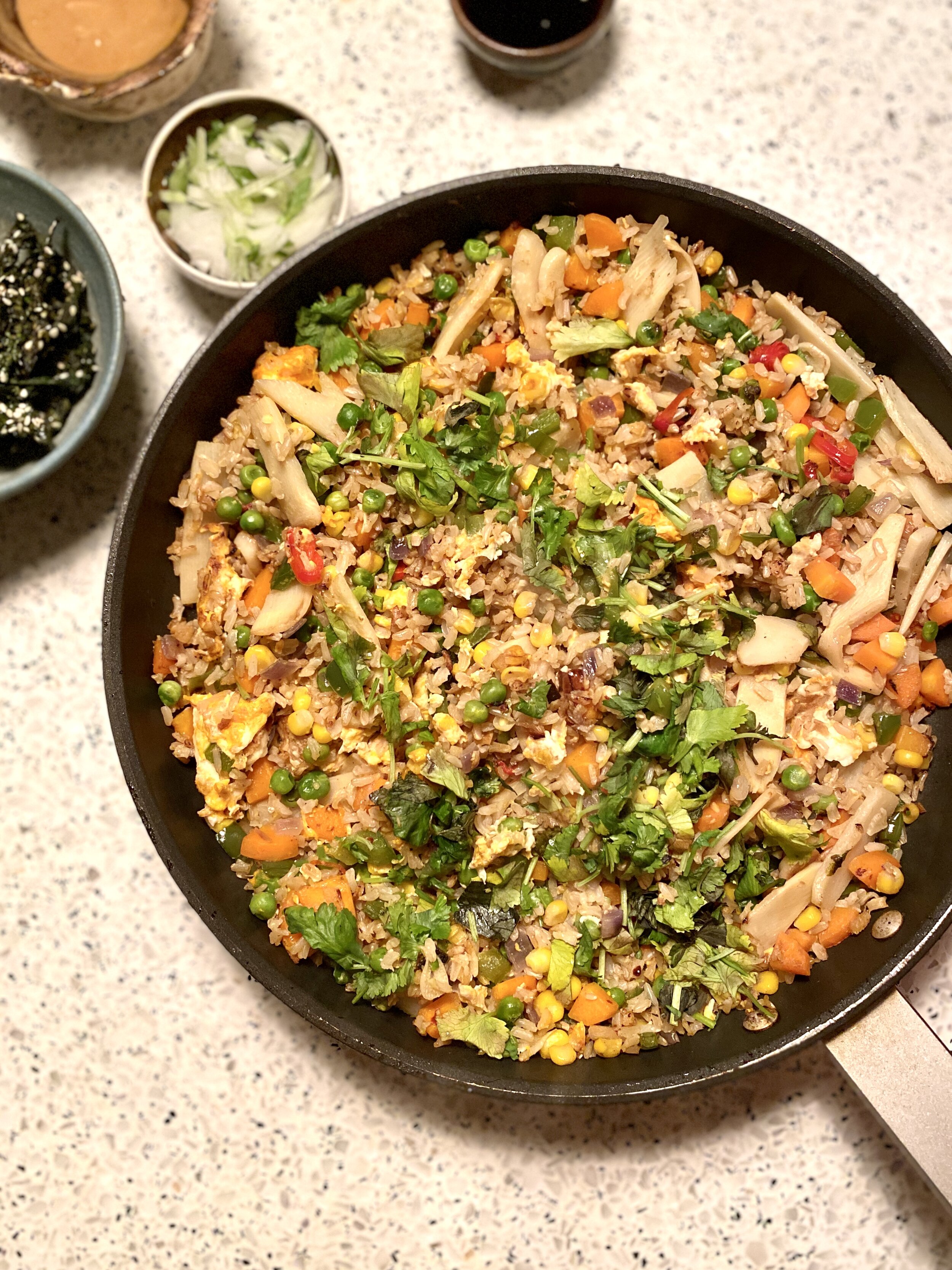 A flat-lay image of a large saucepan full of egg-fried rice