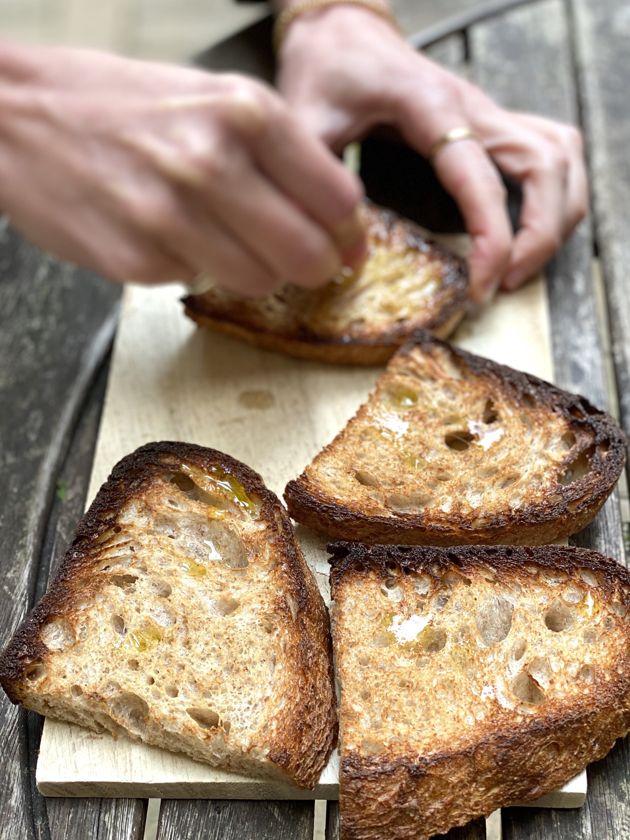 Rubbing garlic on sourdough toast