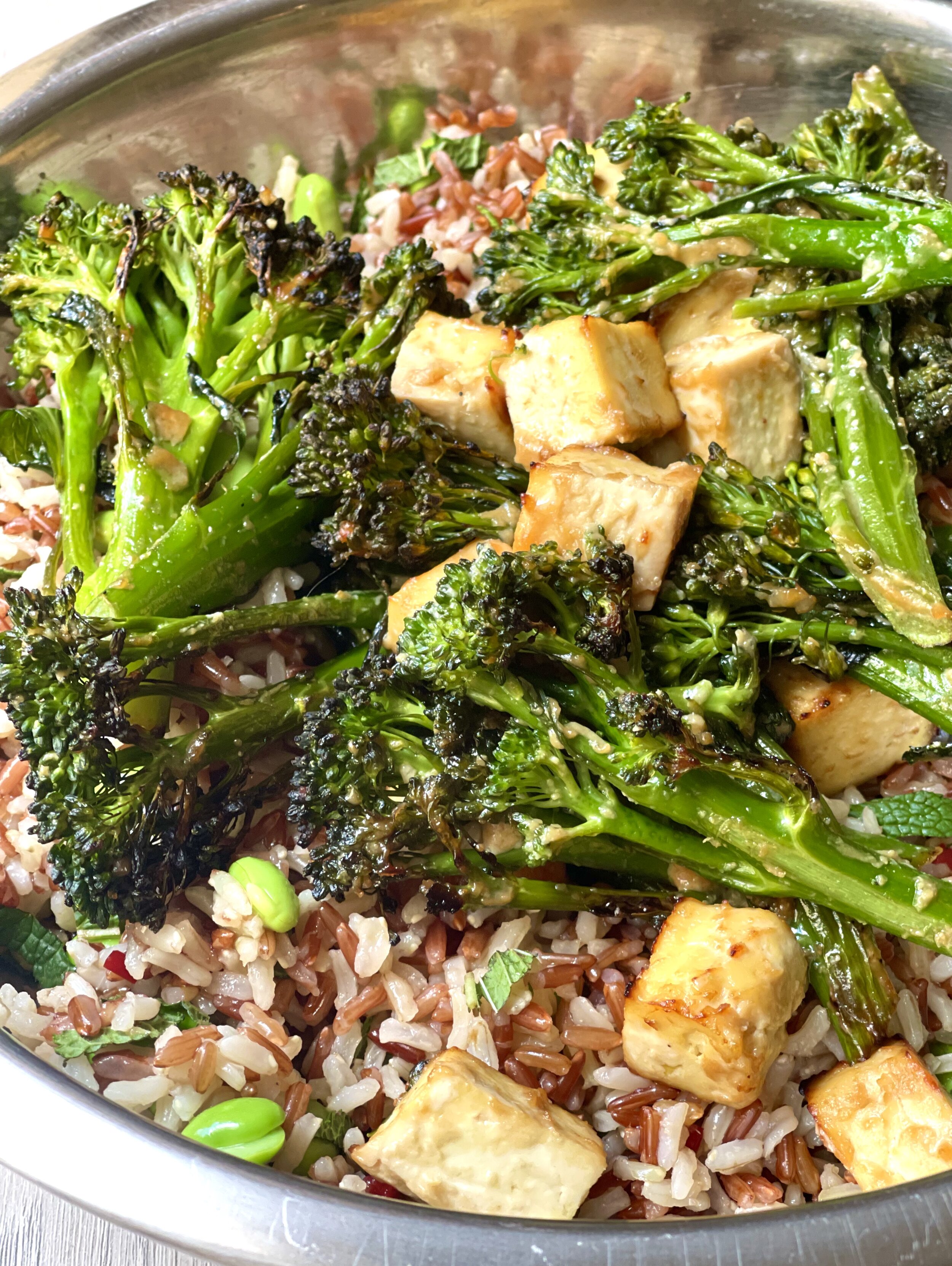 Mixing a miso roasted tofu and wild rice salad
