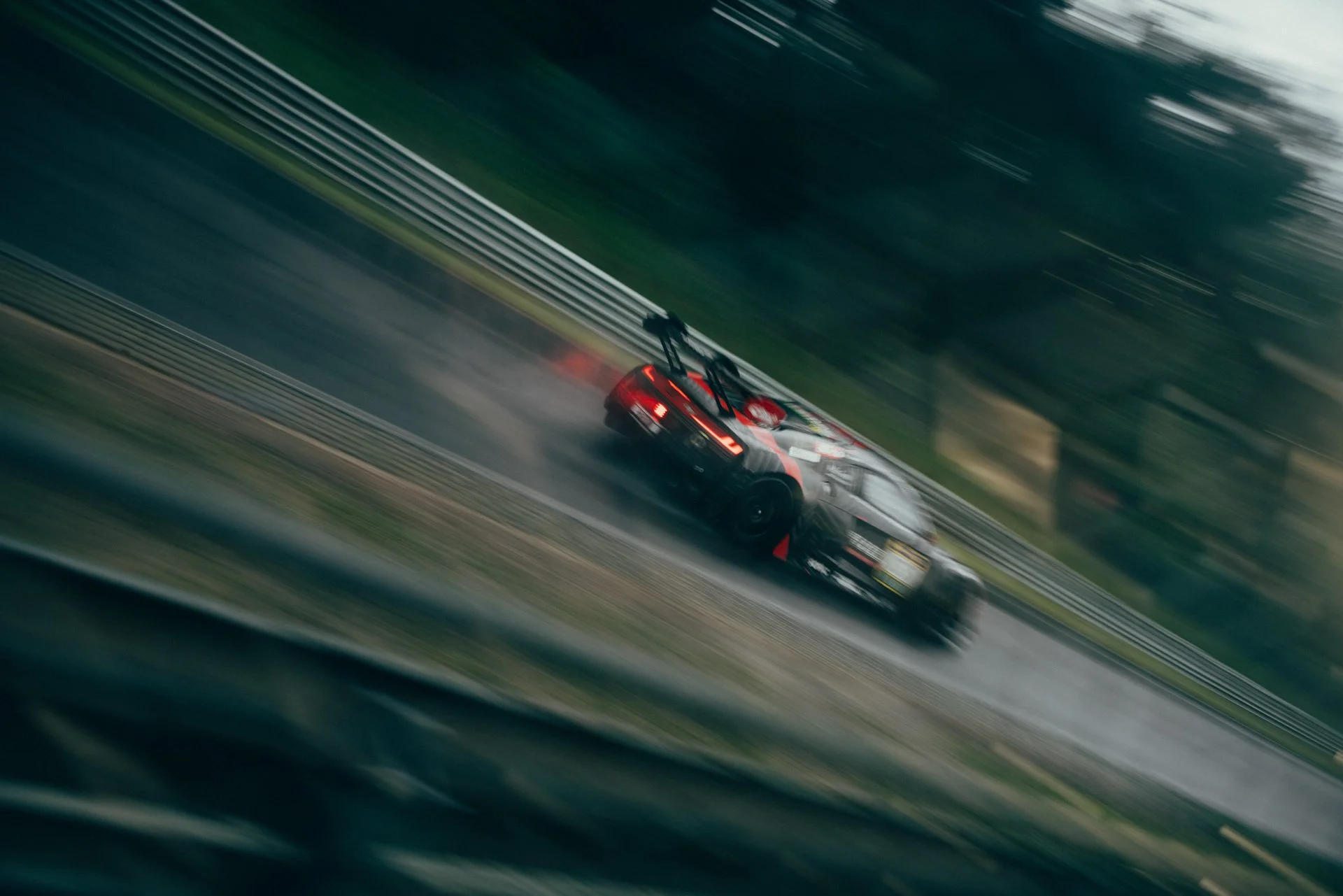 A blurry panning image of an Audi R8 GT3 EVO II in the rain at the Nurburgring 24 hours event. 