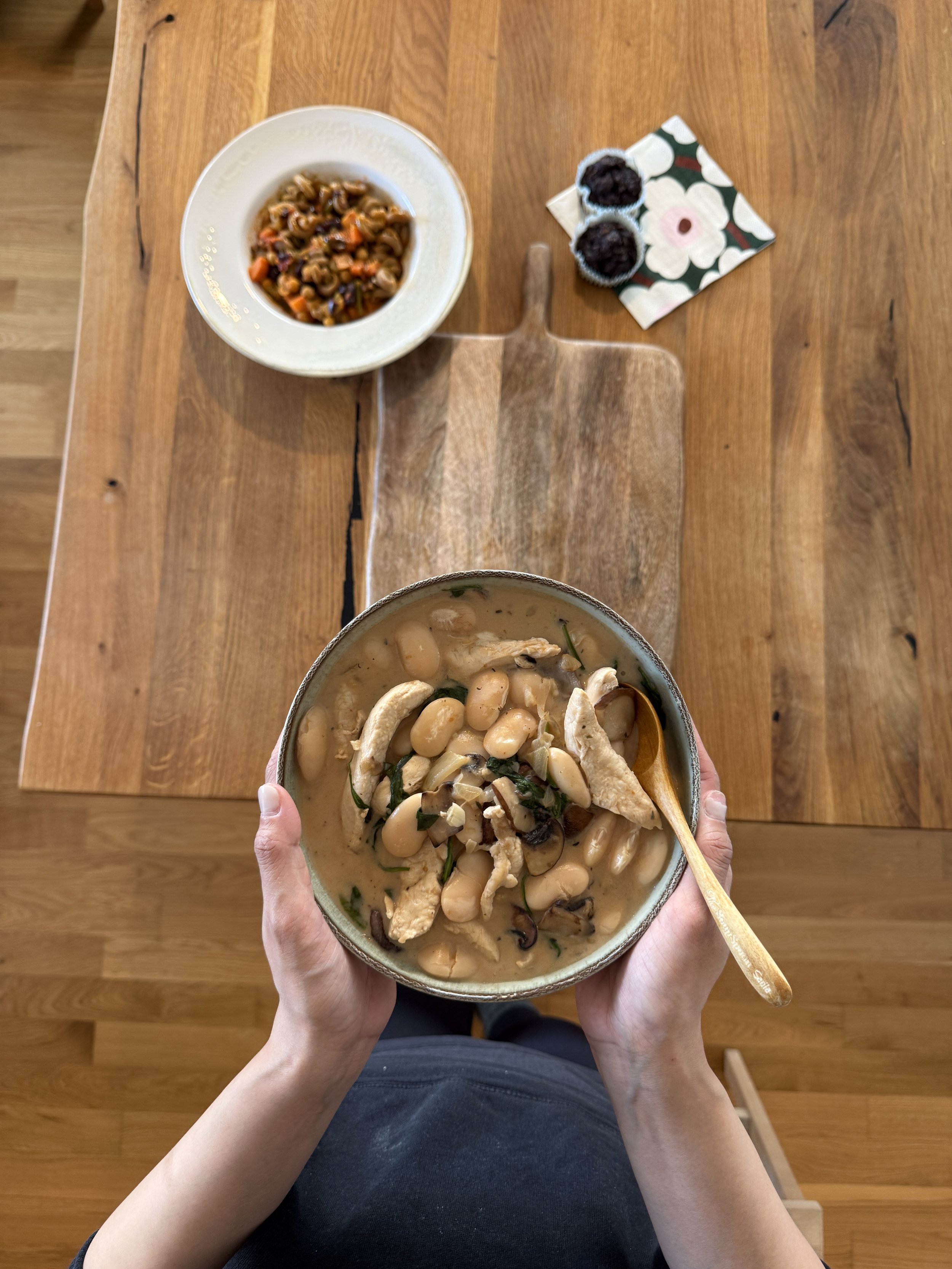 Hands holding a bowl of warm postpartum food — Moongold Meals Berlin