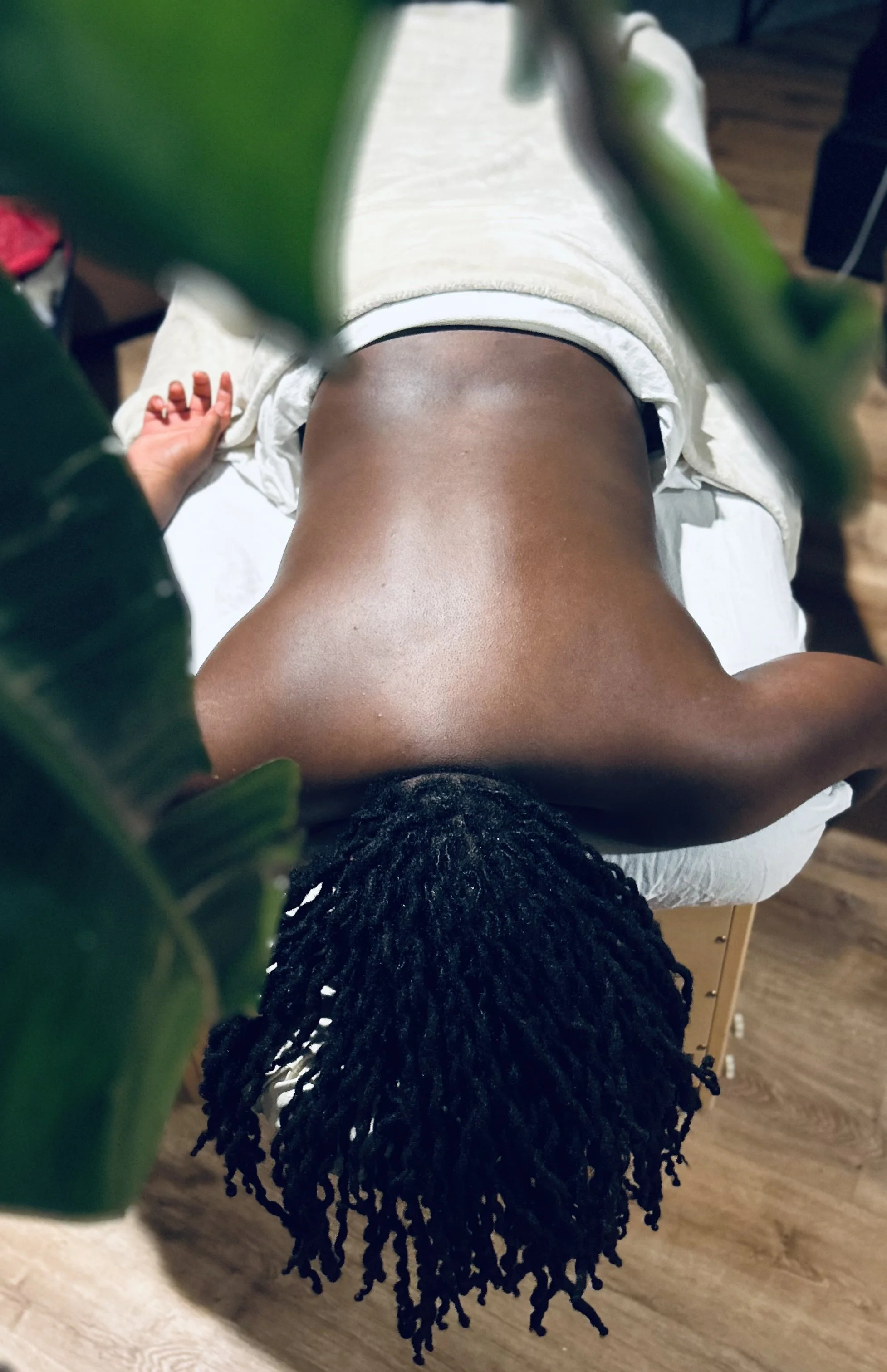 Happy client on a massage table in Evanston IL at Nia Wellness Oasis