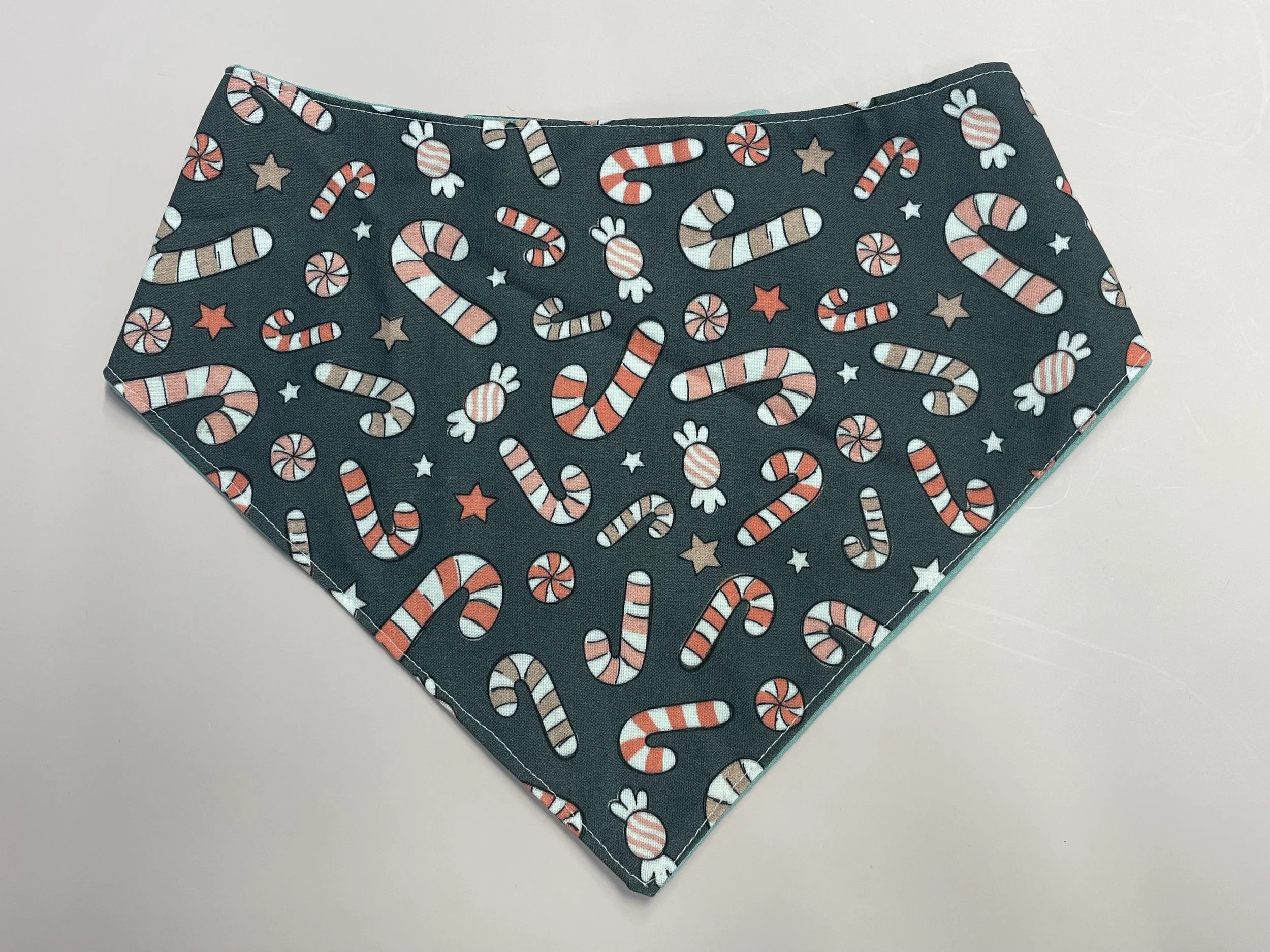 Holiday candy canes on grey bandana.jpeg