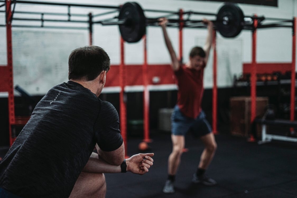 Coach watching a member during a fitness class