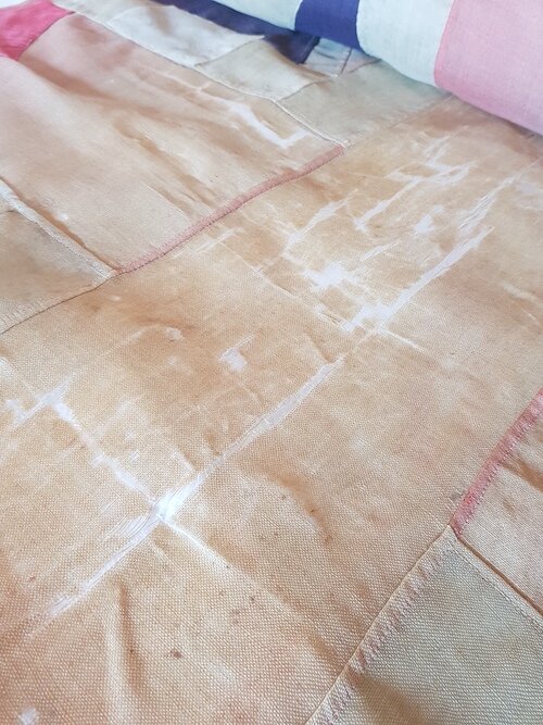 Flattening and aligning the very brittle textile of the flag, in preparation for conservation repair. Lara RSL.
© Tiaki Objects Conservation.