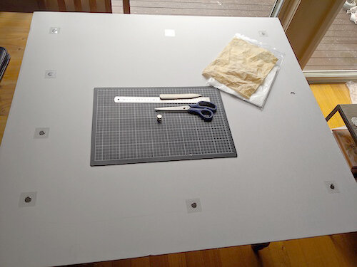 Preparing a mount board, with rare earth neodymium magnets, embedded in the double-wall archival board. Private Collection.
© Tiaki Objects Conservation.