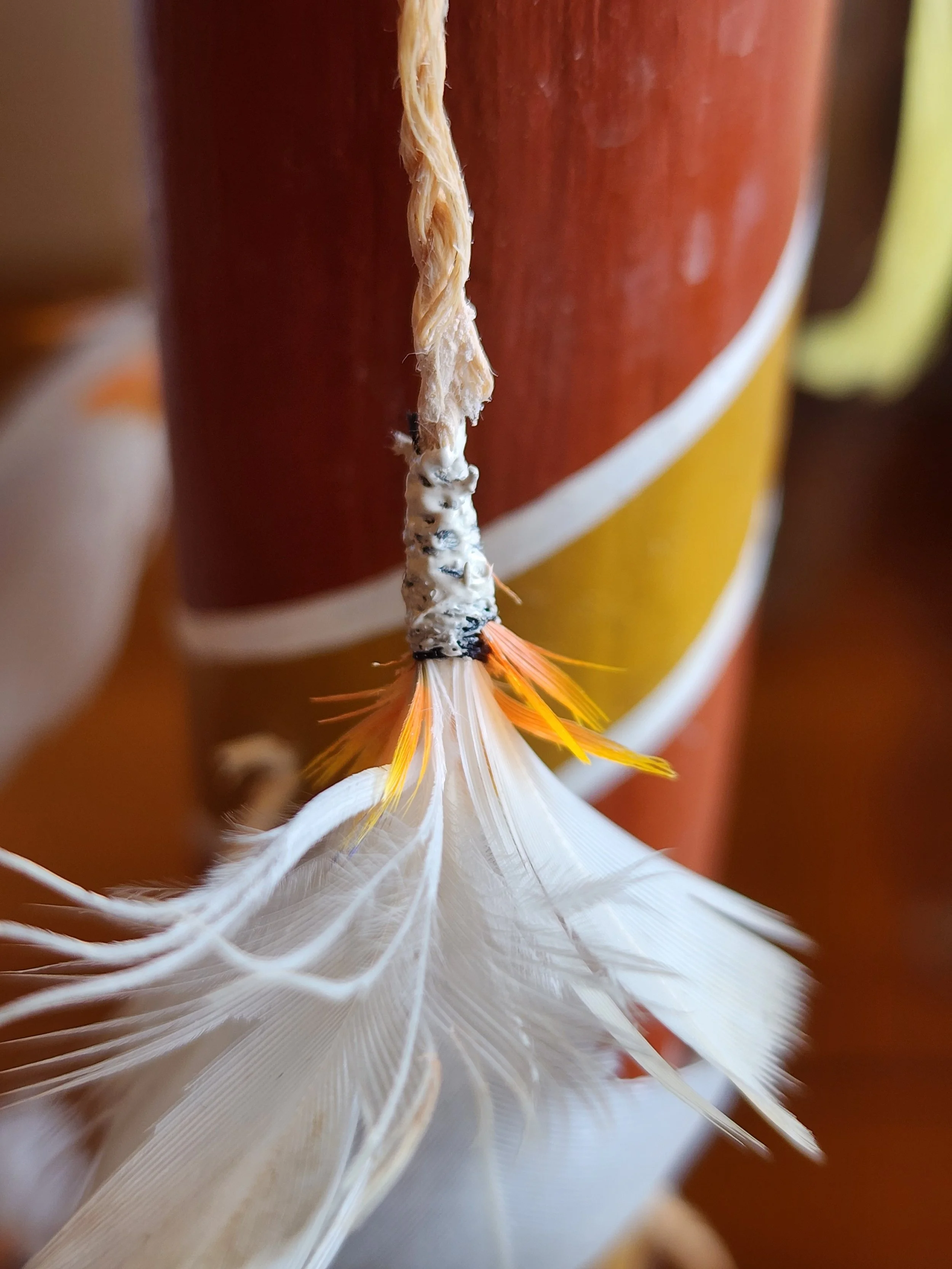 Close-up of feather detail on a cultural heritage object, showing material construction and conservation care