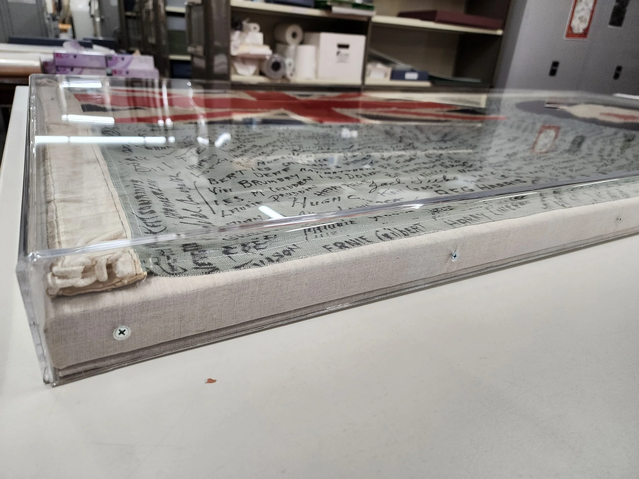 Textile flag protected in custom housing as part of preventive conservation in a museum collection