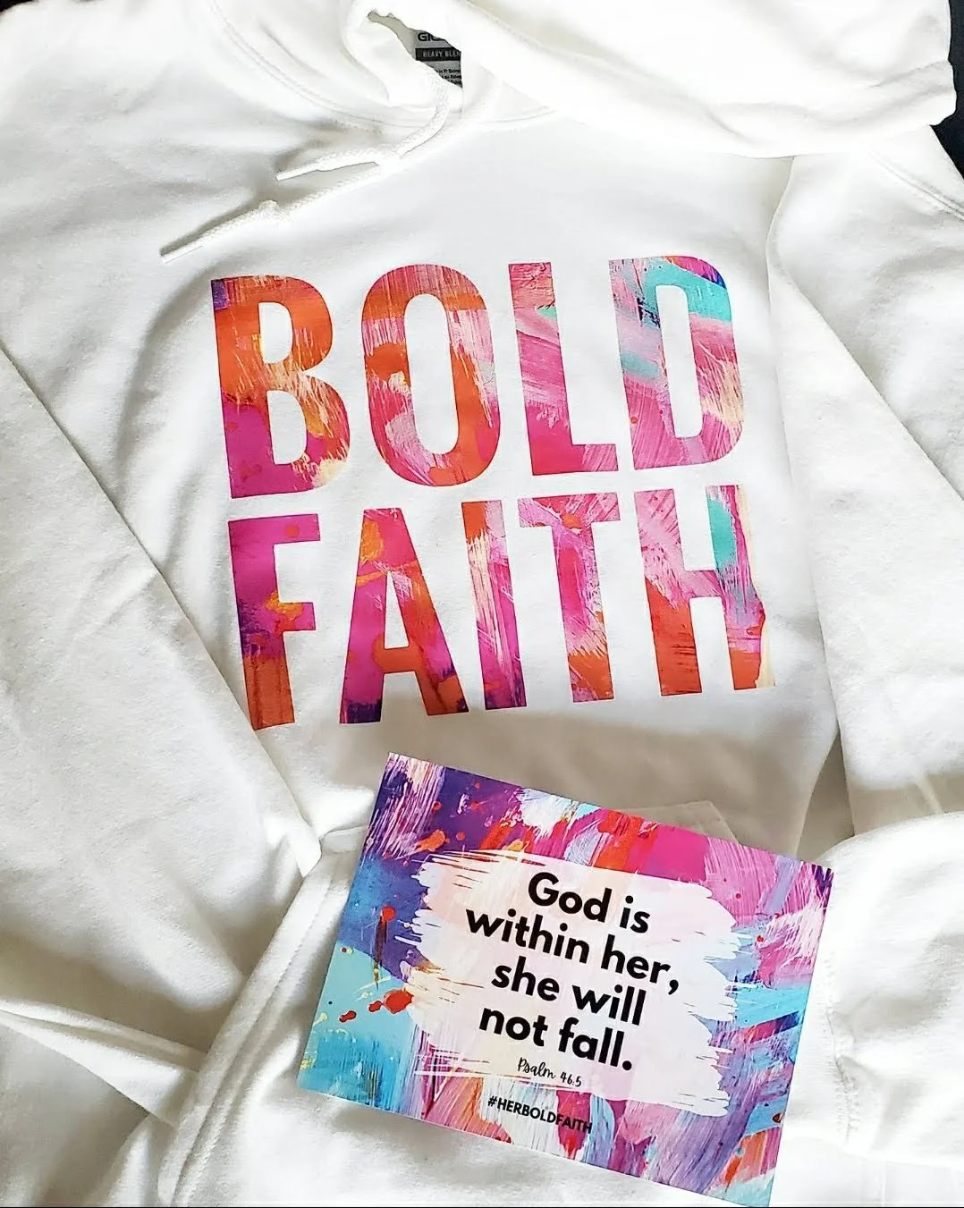 White hoodie with pink abstract designed Bold Faith text