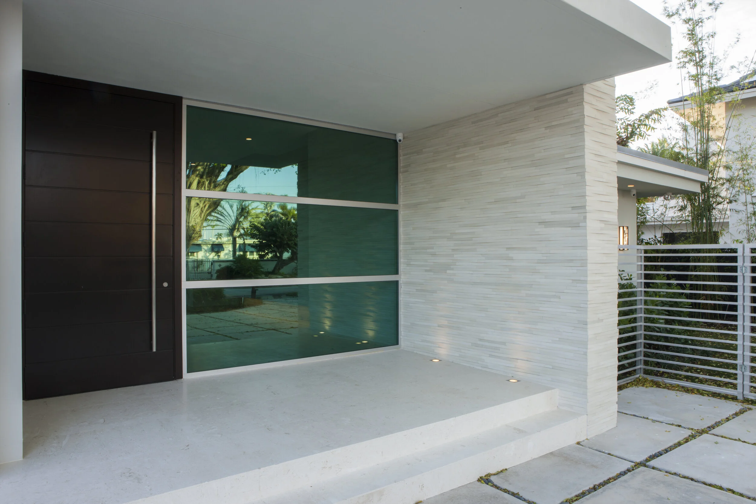 Harbor Beach custom luxury contemporary home - front entrywood door plus glass panels