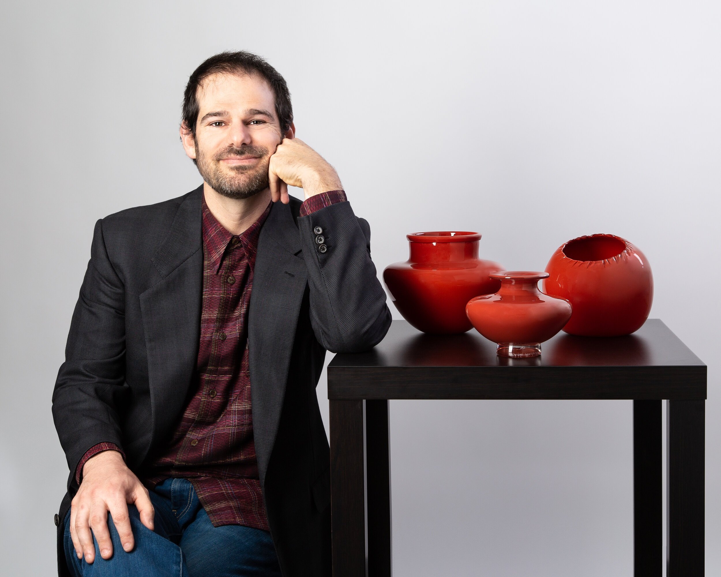 Artist, Zach Rudolph with his blown glass creations.