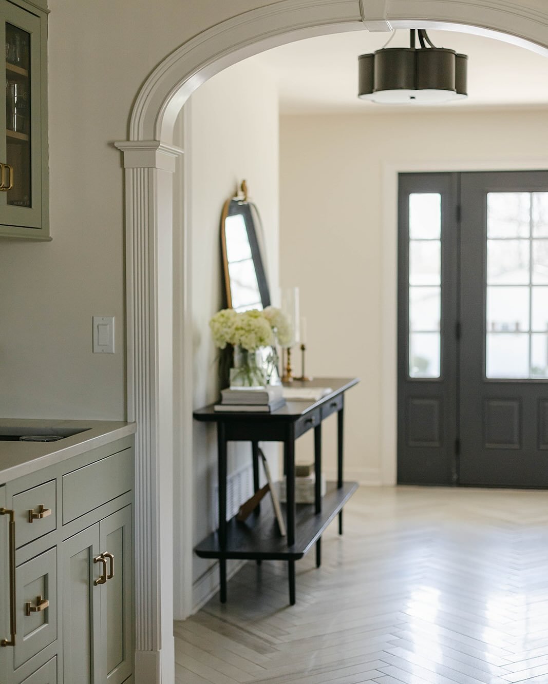 Our number one goal for this house was to bring in the charm often seen in older homes. More built-ins, archways, millwork and custom doors. 

First on the list was this entry. We removed a closet, opened the basic doorway and framed an elliptical ar