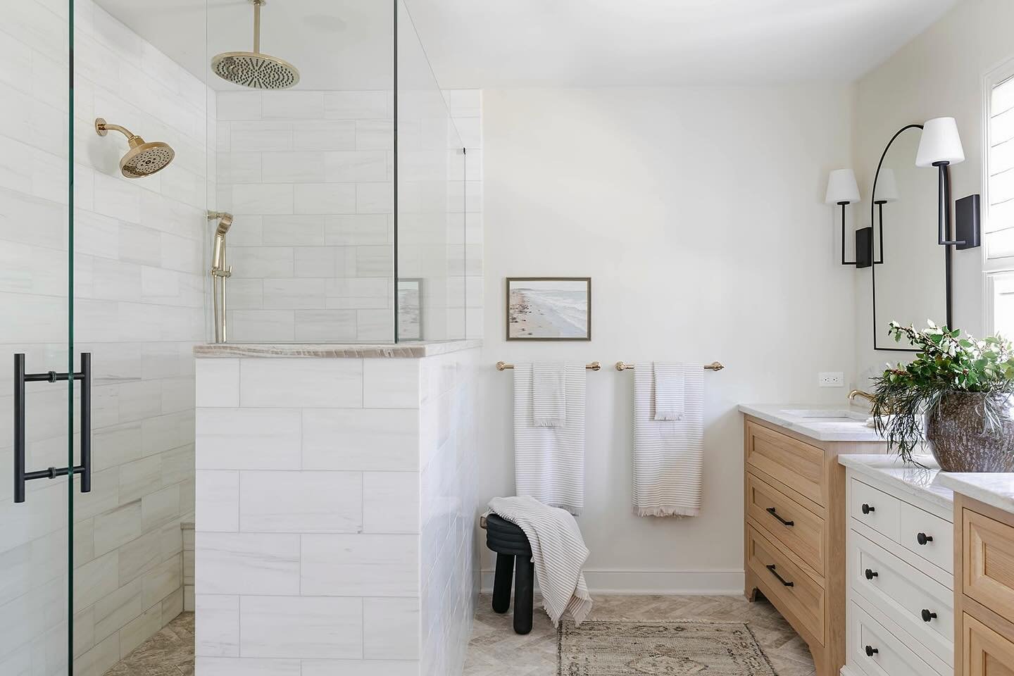 All natural stones and a quiet mix of polished brass and black. We used two different types of marble tiles, quartzite countertops and white oak for a calm and inviting palette in this primary bathroom. 

Designed and styled by us @stellanoirdesign 
