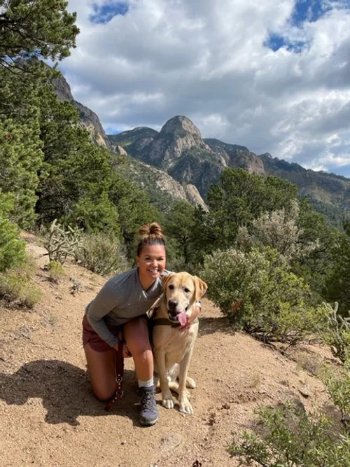 sarah and her dog on a hike in the Sandia Mountains