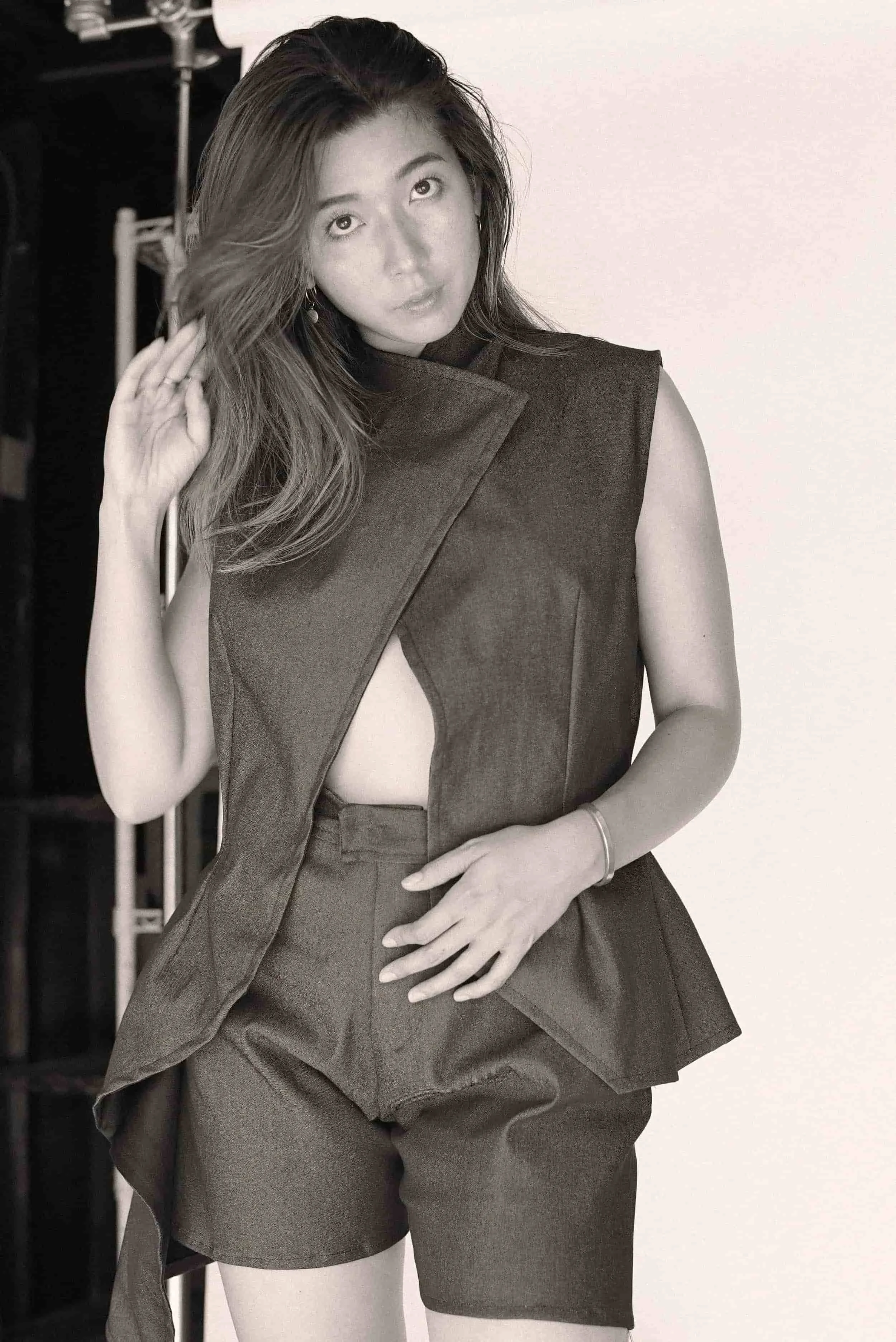 Model wearing a sleeveless blazer and tailored shorts from Keagan Roberson.