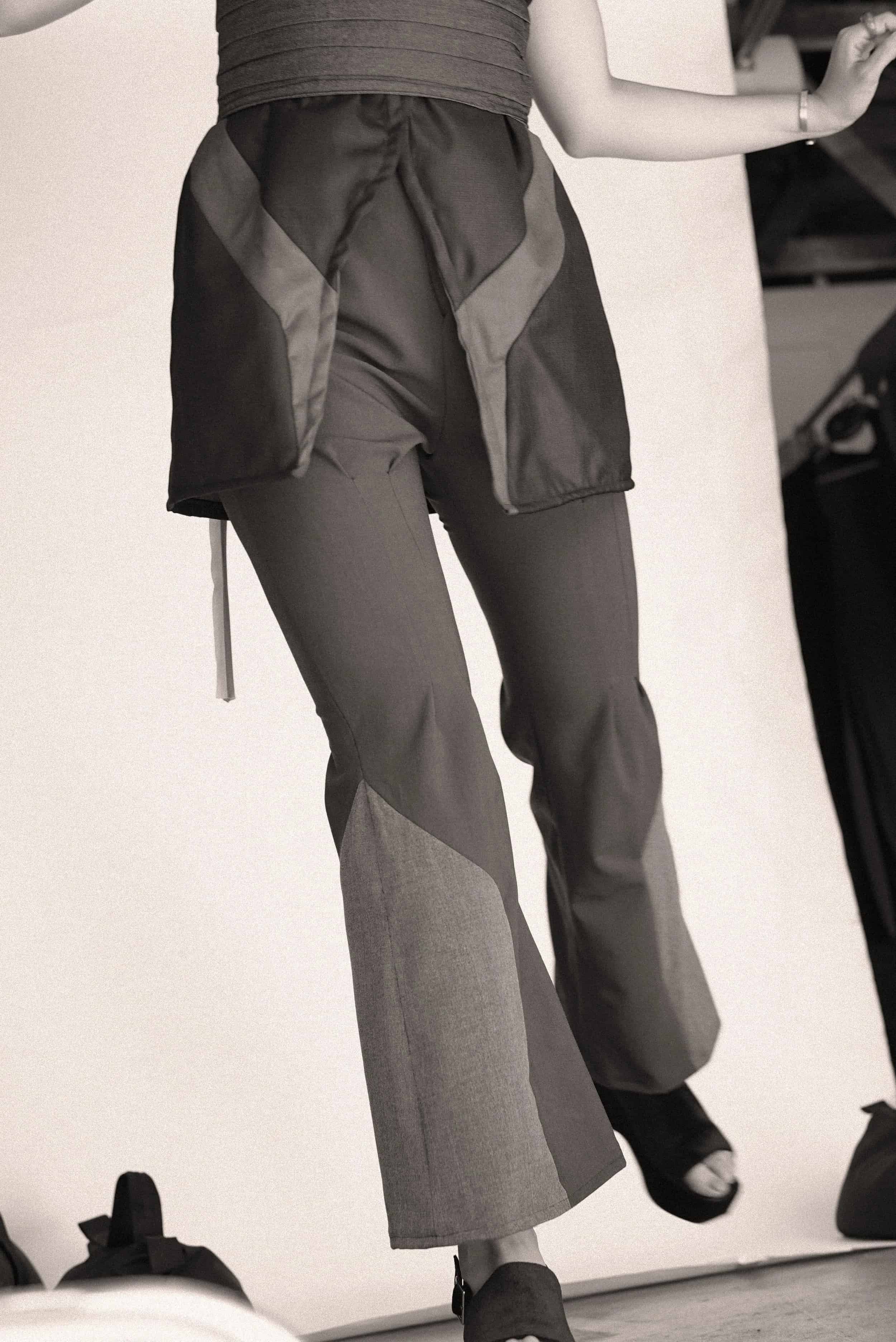 Close-up detail of layered trousers and jacket from Keagan Roberson.