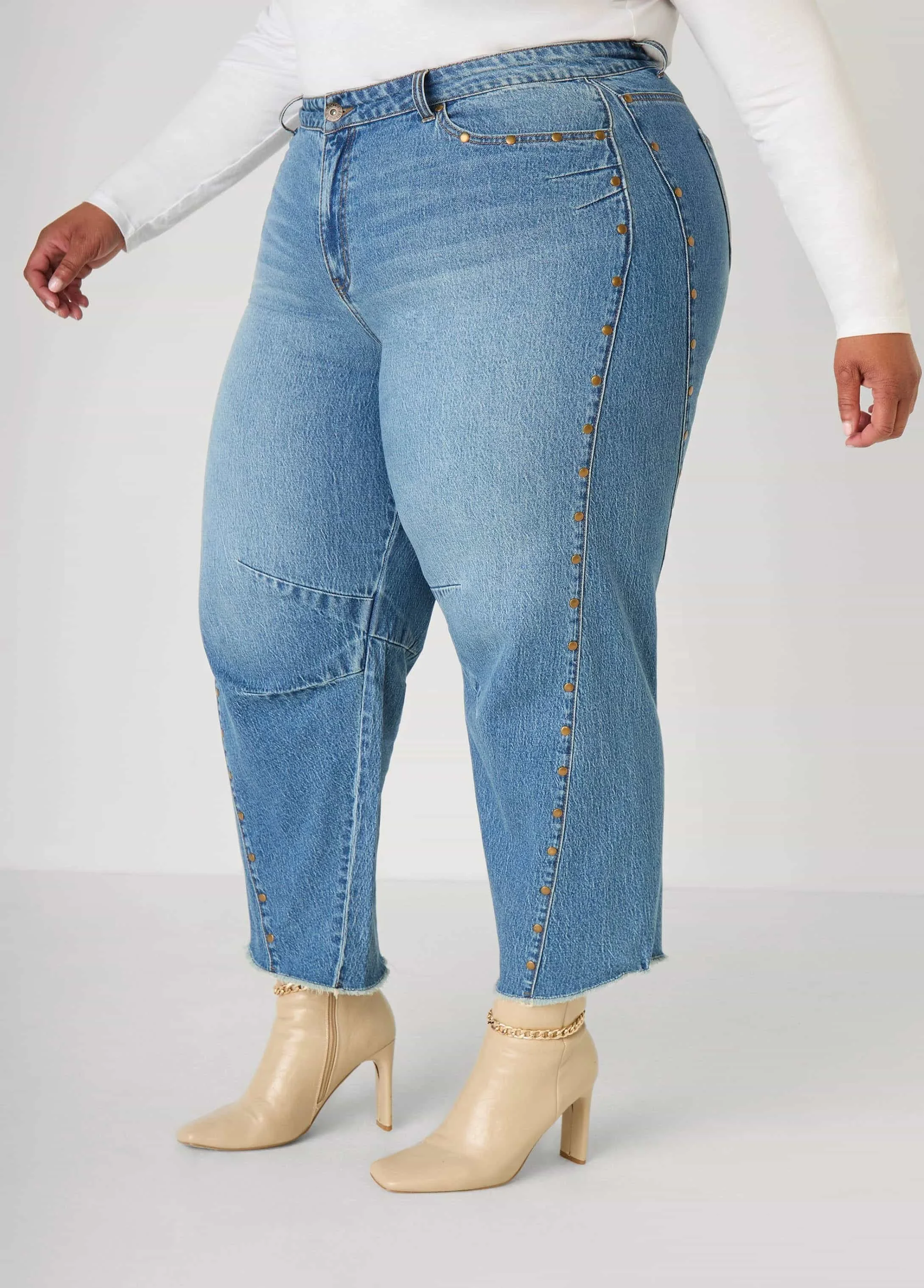 Close-up of light blue high-waisted jeans with rivet detailing by Keagan Roberson.