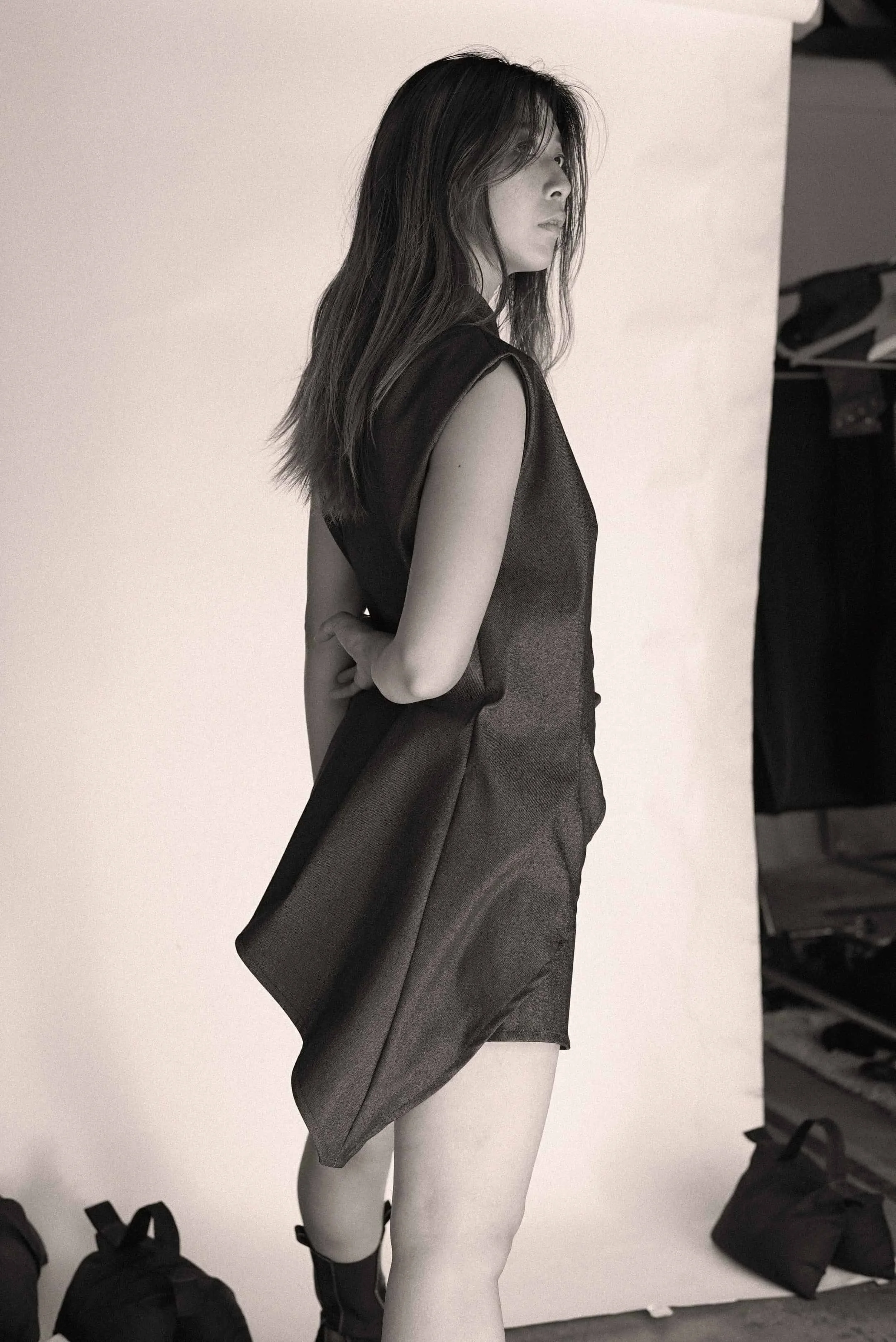 Model in a sleeveless dark look from Keagan Roberson, photographed in studio.