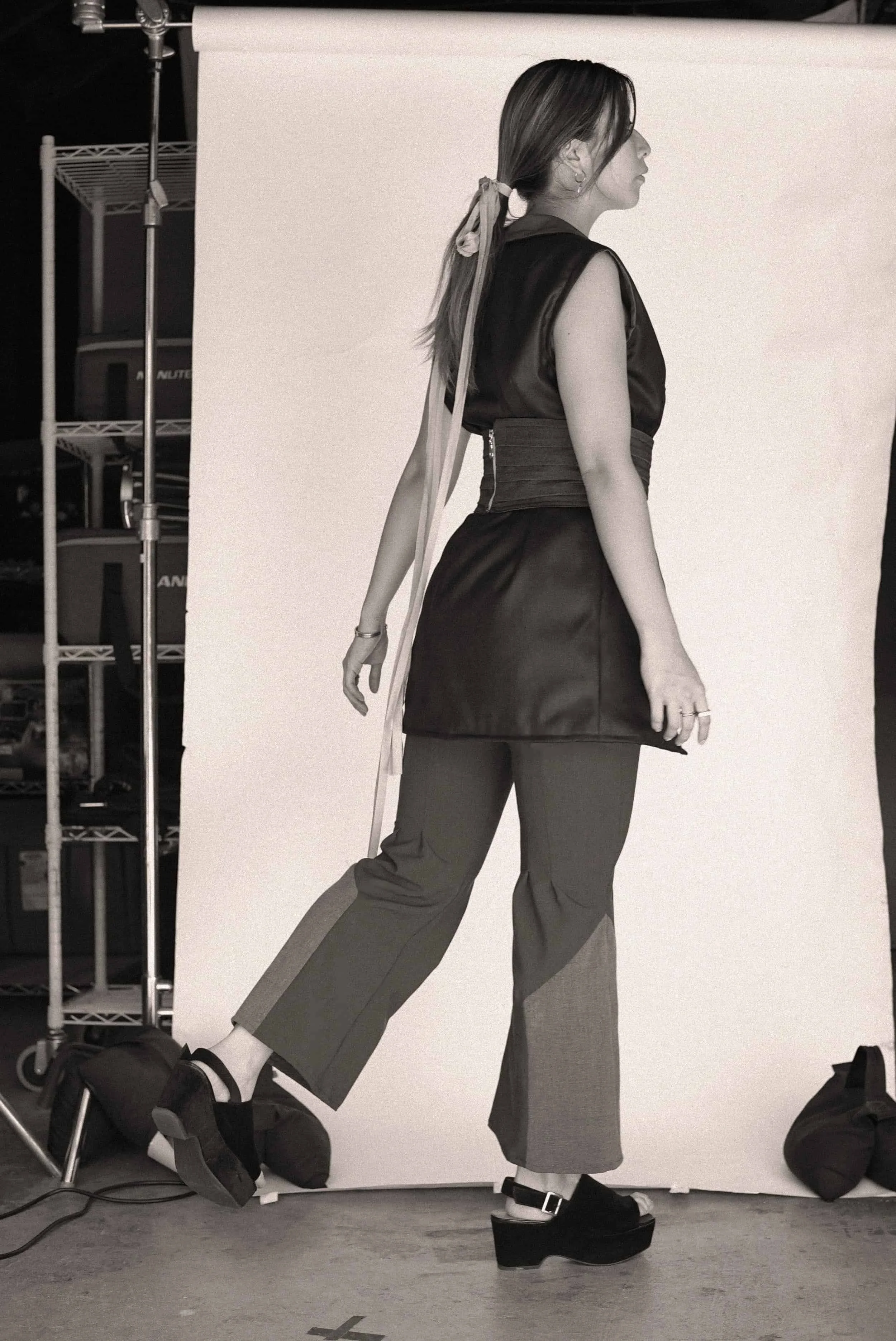 Model in a black sleeveless top and wide-leg trousers from Keagan Roberson.