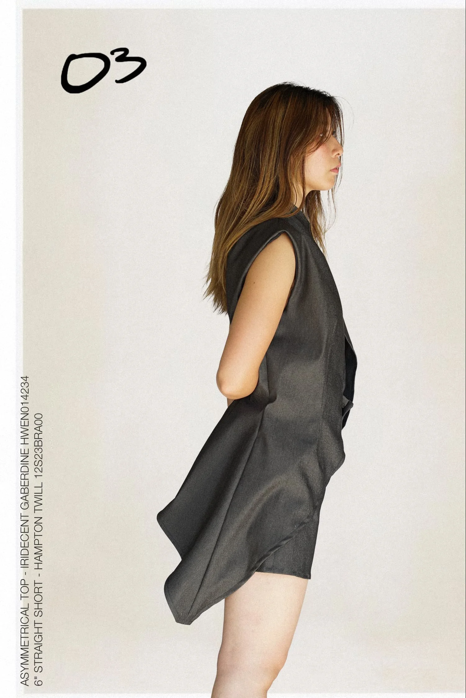 Side view of a model wearing an asymmetrical black set from Keagan Roberson.